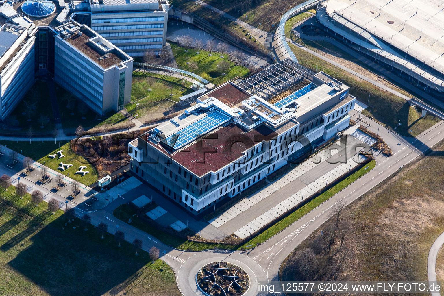 Star-shaped office buildings of the SAP Deutschland SE & Co. KG at the forest edged in Walldorf in the state Baden-Wuerttemberg from above