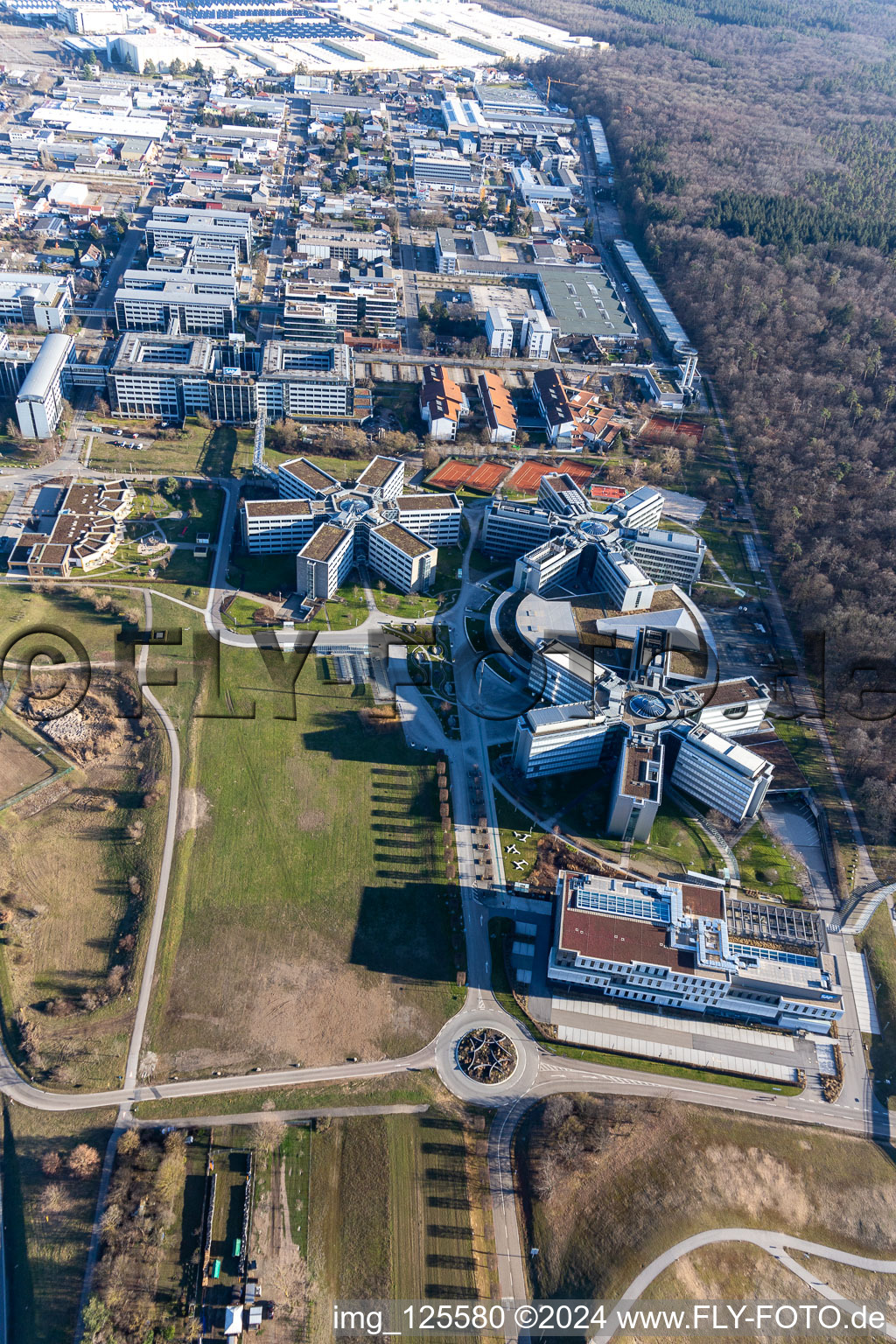 Star-shaped office buildings of the SAP Deutschland SE & Co. KG at the forest edged in Walldorf in the state Baden-Wuerttemberg seen from above