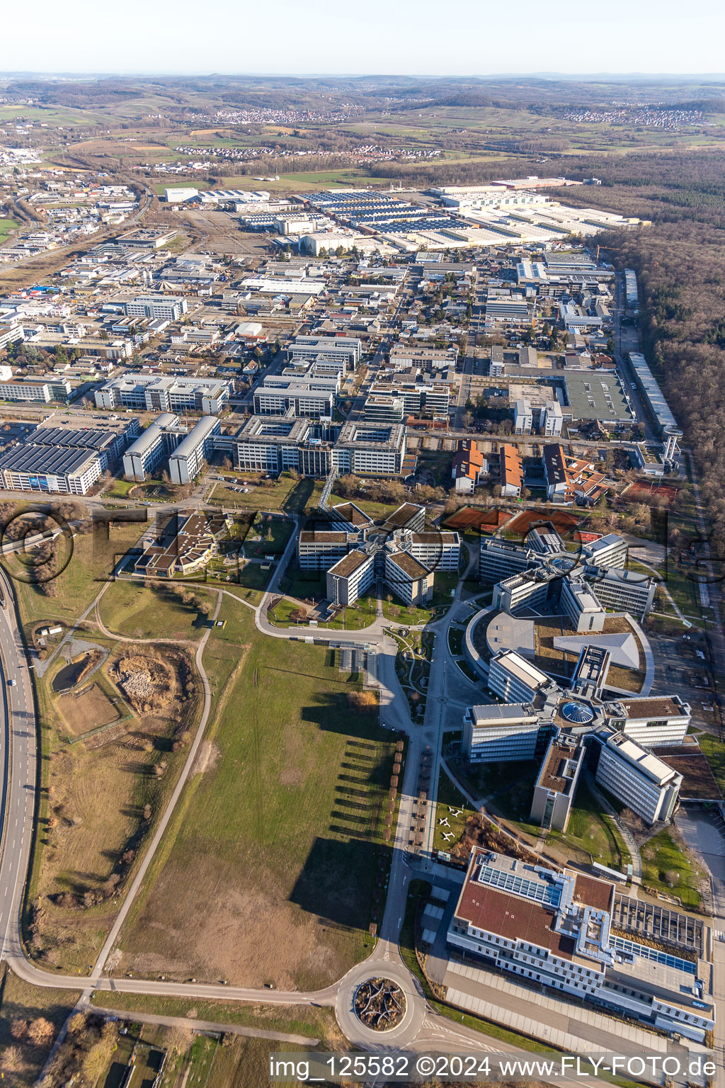 Star-shaped office buildings of the SAP Deutschland SE & Co. KG at the forest edged in Walldorf in the state Baden-Wuerttemberg from the plane