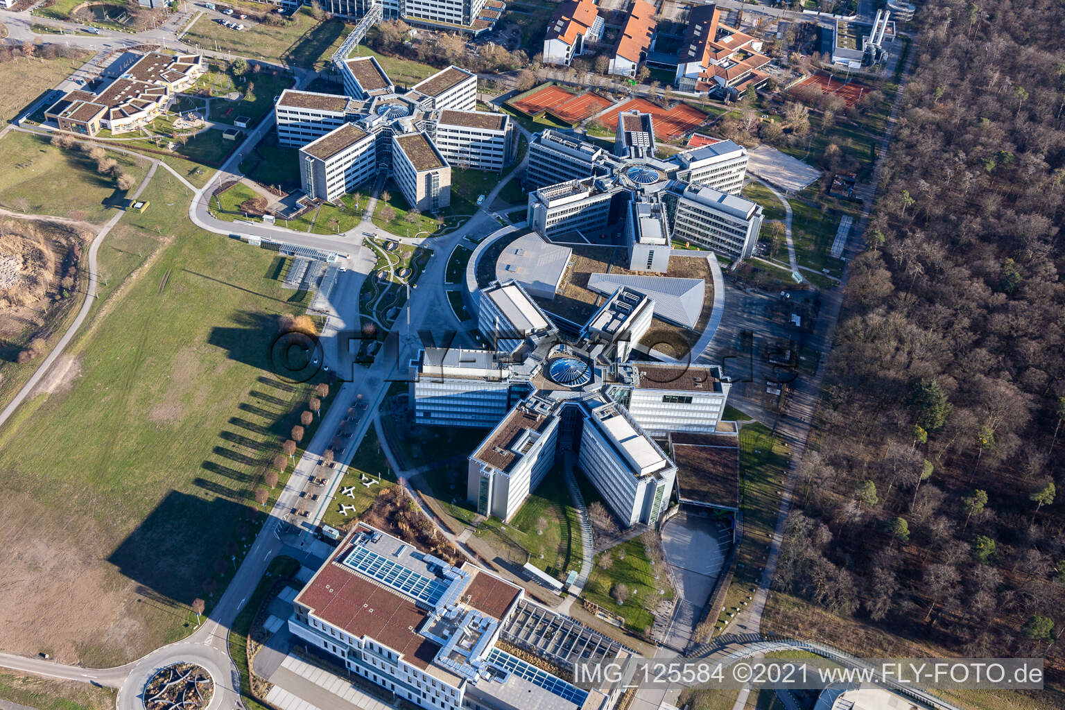 Bird's eye view of Star-shaped office buildings of the SAP Deutschland SE & Co. KG at the forest edged in Walldorf in the state Baden-Wuerttemberg