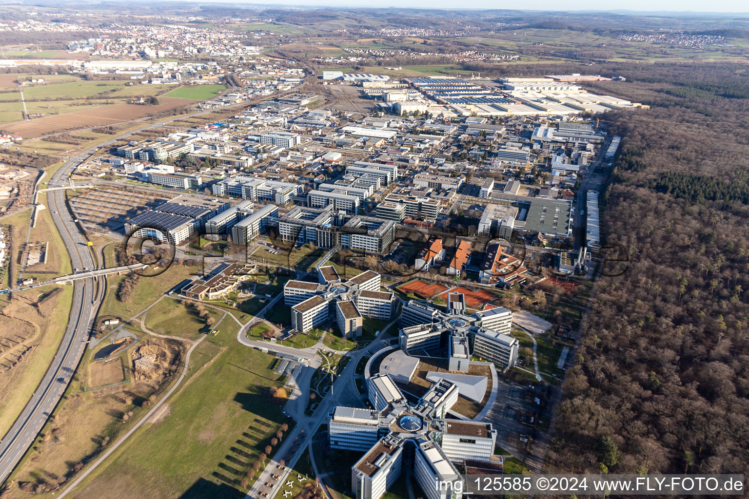 Star-shaped office buildings of the SAP Deutschland SE & Co. KG at the forest edged in Walldorf in the state Baden-Wuerttemberg viewn from the air