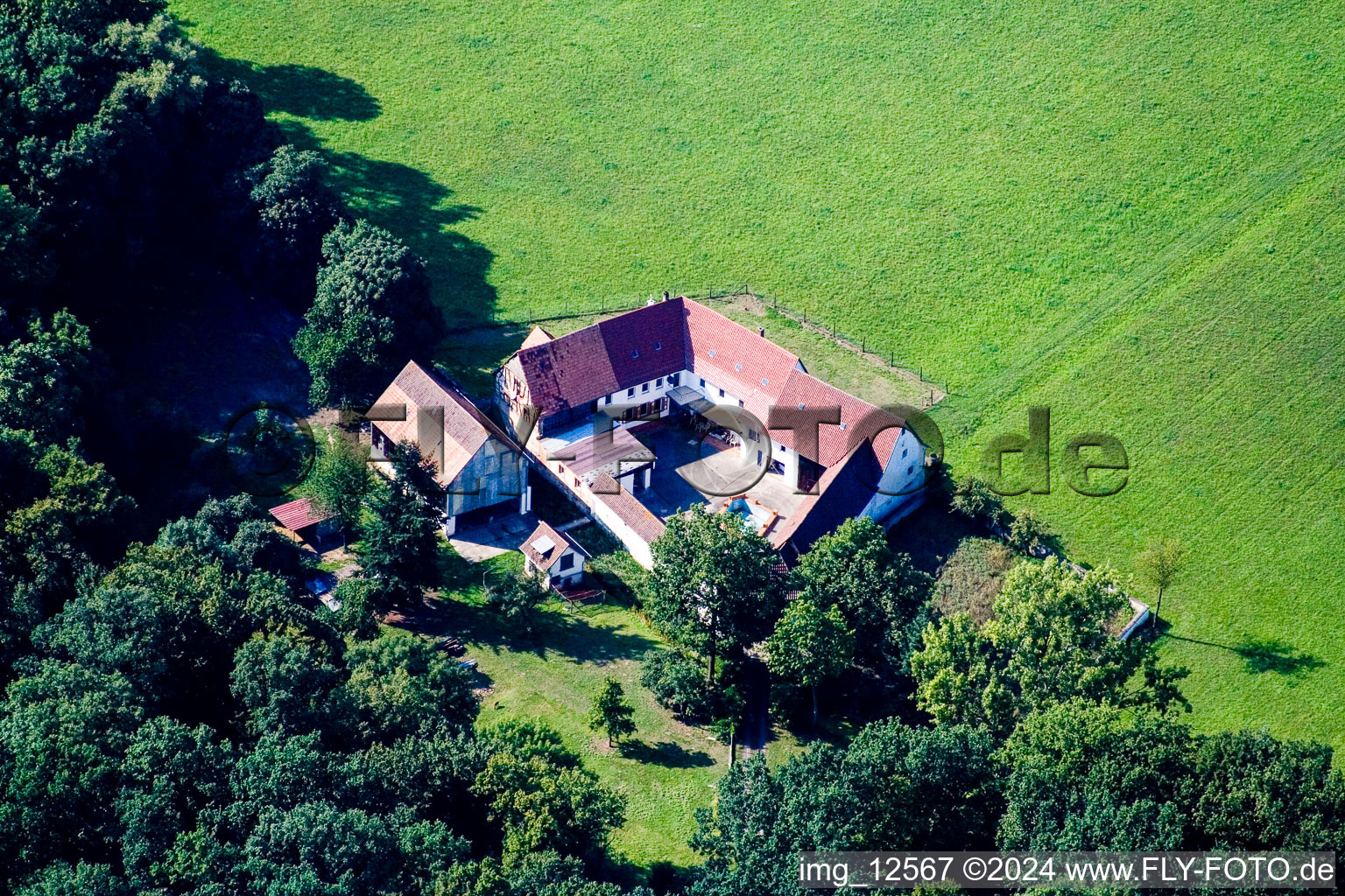 Herrenmühle - homestead of a farm on the edge of cultivated fields in the district Minderslachen in Kandel in the state Rhineland-Palatinate, Germany