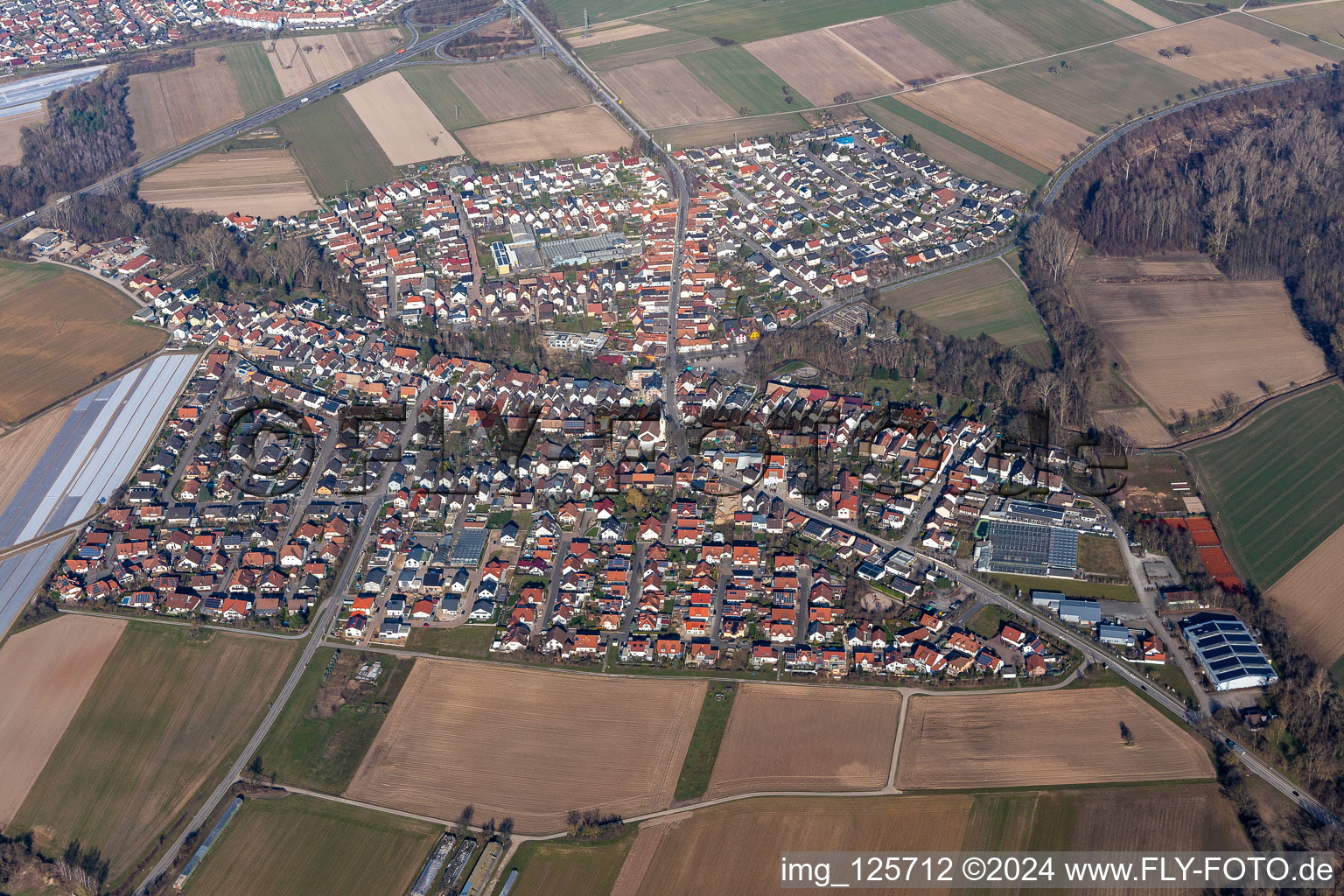 Aerial view of Village - view on the edge of agricultural fields and farmland in Kuhardt in the state Rhineland-Palatinate, Germany