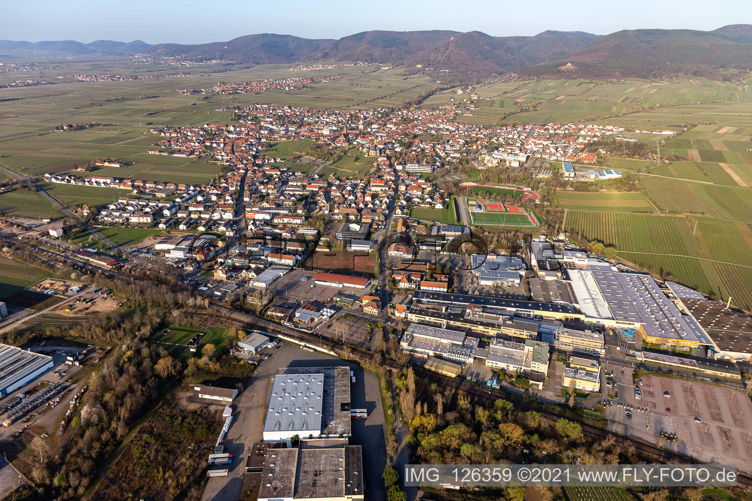 Aerial photograpy of Location view of the streets and houses of residential areas in the rhine valley landscape surrounded by mountains in Edenkoben in the state Rhineland-Palatinate, Germany