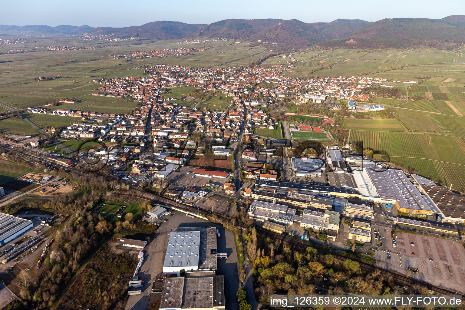 Aerial photograpy of Location view of the streets and houses of residential areas in the rhine valley landscape surrounded by mountains in Edenkoben in the state Rhineland-Palatinate, Germany