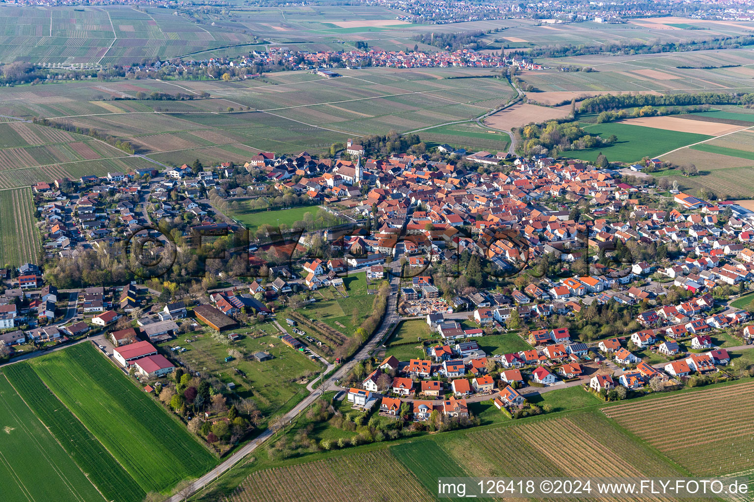 Agricultural land and field borders surround the settlement area of the village in Moerzheim in the state Rhineland-Palatinate, Germany from above