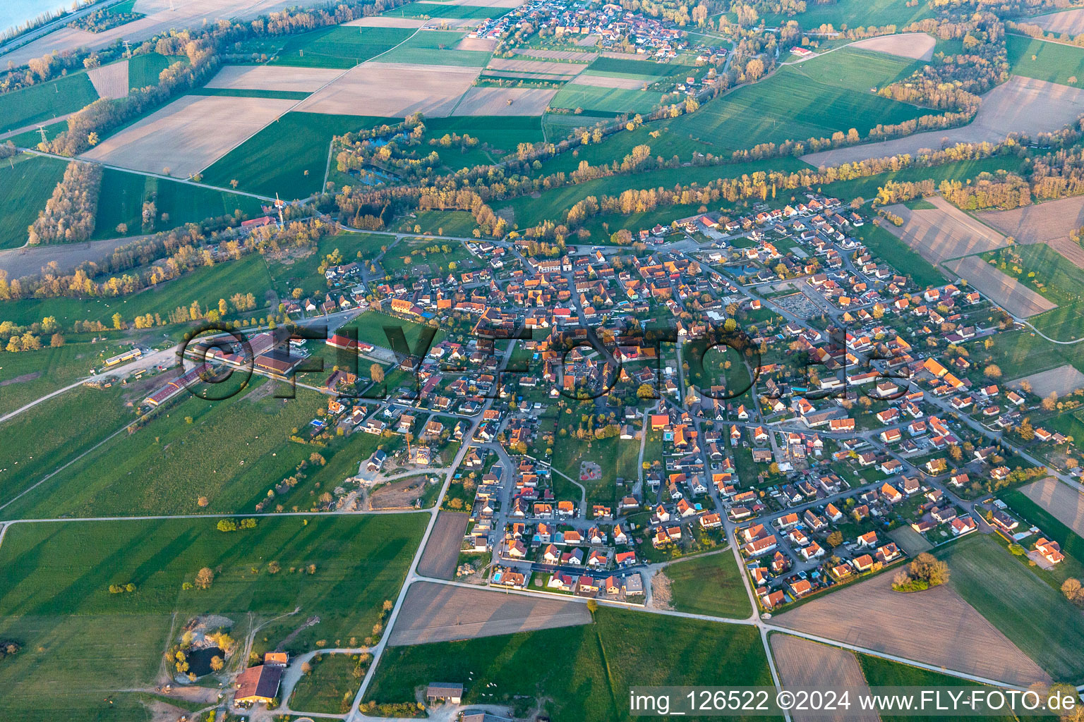 Village - view on the edge of agricultural fields and farmland in Forstfeld in Grand Est, France