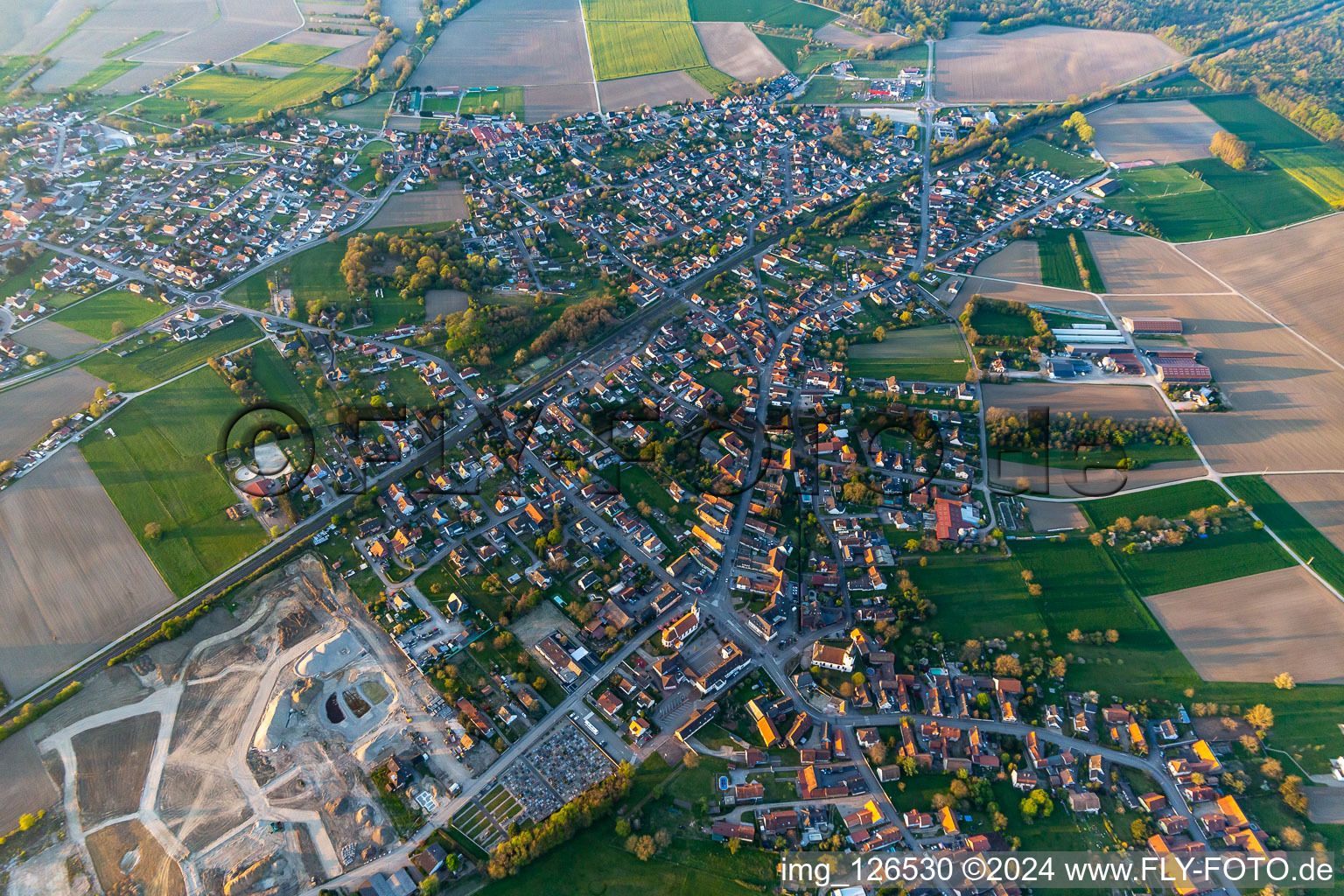 Village - view on the edge of agricultural fields and farmland in Sessenheim in Grand Est, France