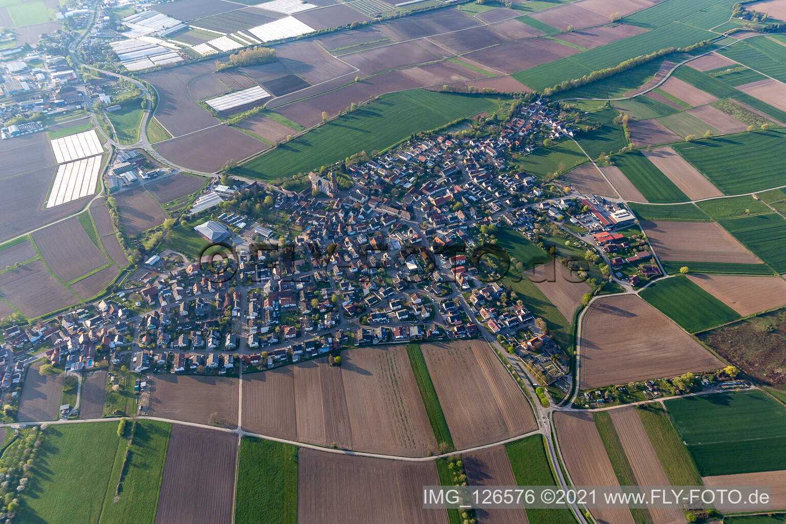 Aerial view of Agricultural land and field boundaries surround the settlement area of the village in Schuttern in the state Baden-Wuerttemberg, Germany