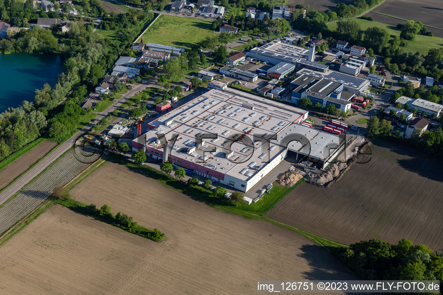 Oblique view of Building and production halls on the premises of Coca-Cola European Partners Deutschland GmbH in Neureut in the state Baden-Wuerttemberg, Germany
