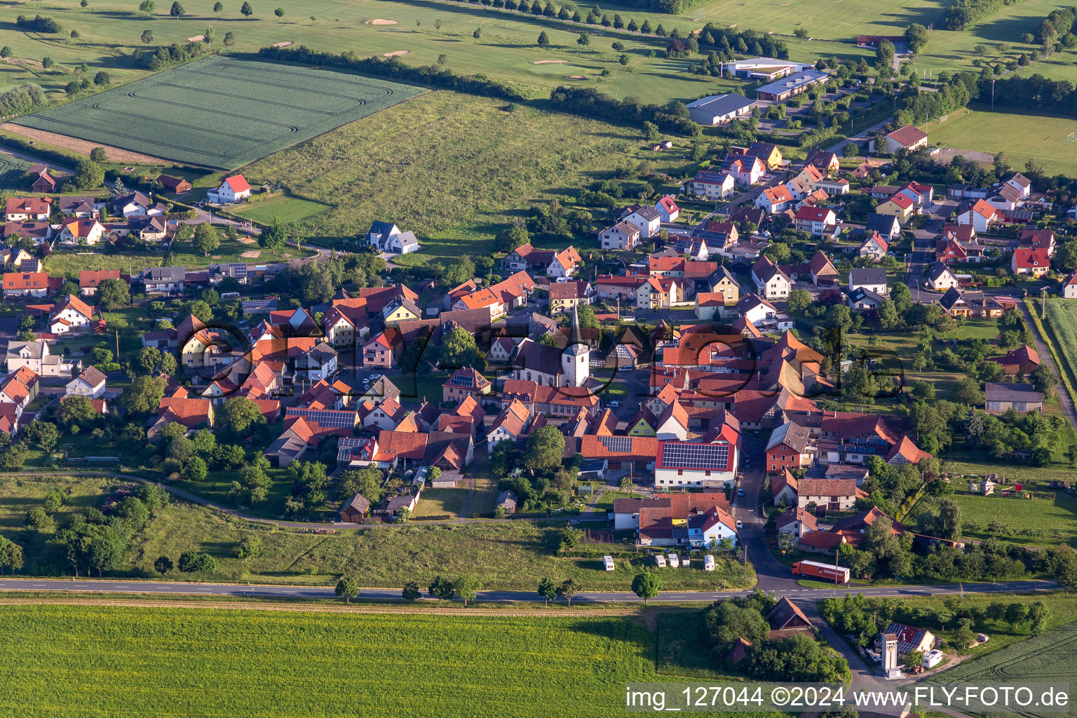 Aerial view of Village view on the edge of agricultural fields and land in Loeffelsterz in the state Bavaria, Germany