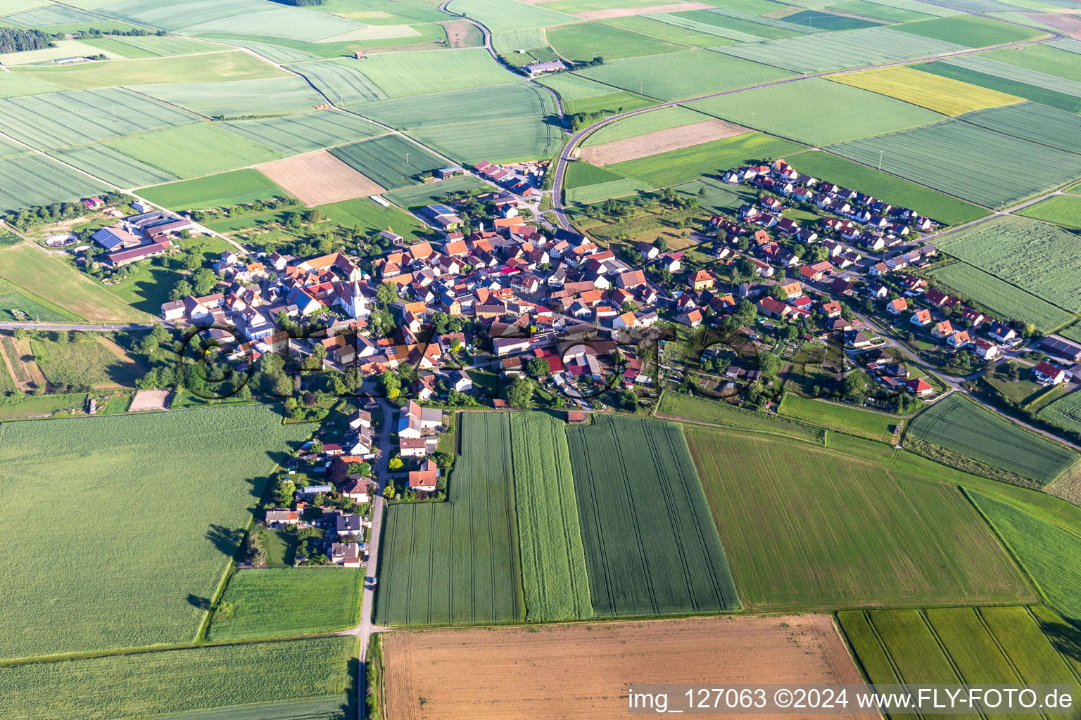 Village - view on the edge of agricultural fields and farmland in Ebertshausen in the state Bavaria from above