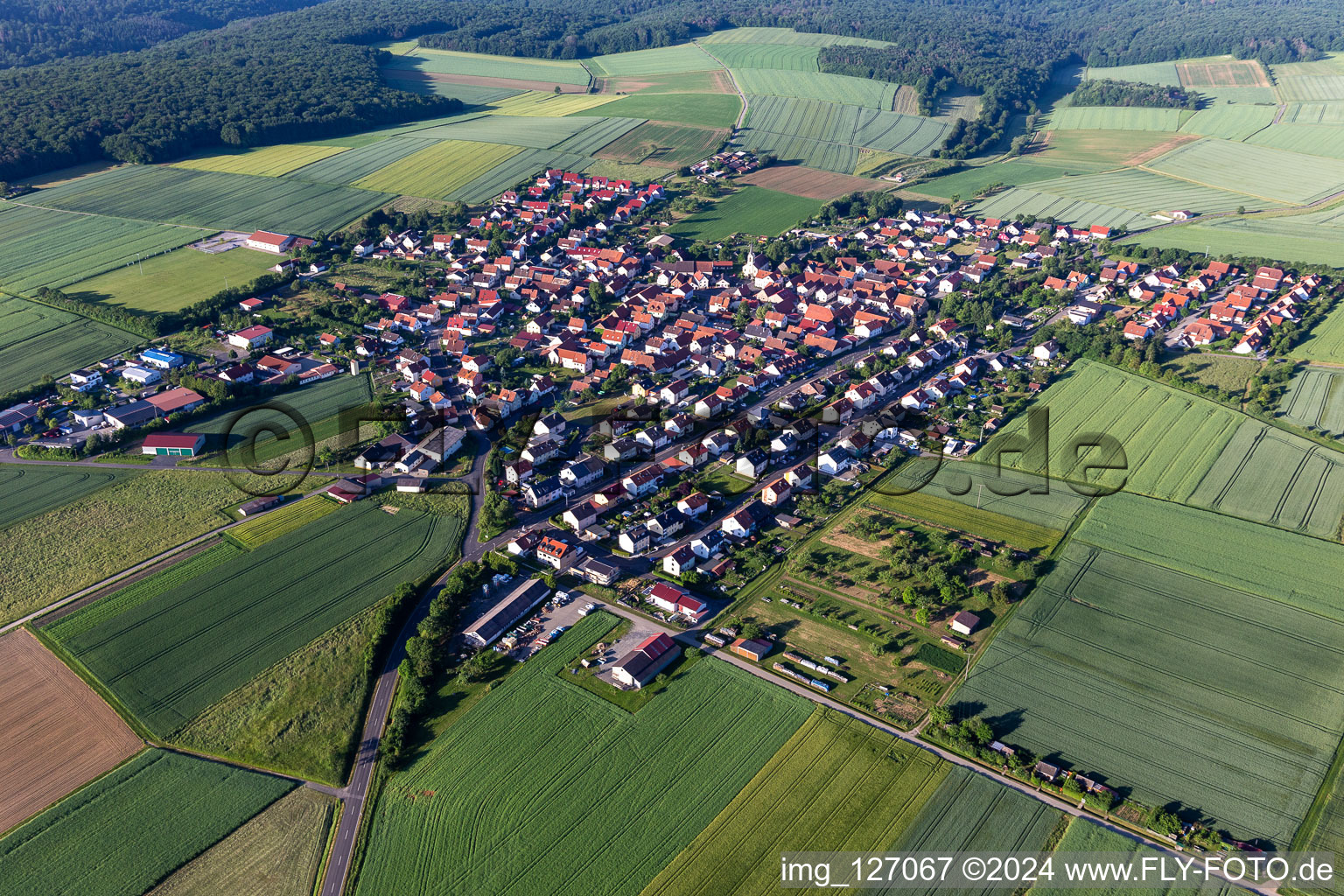 Aerial photograpy of Agricultural land and field boundaries surround the settlement area of the village in Hesselbach in the state Bavaria, Germany