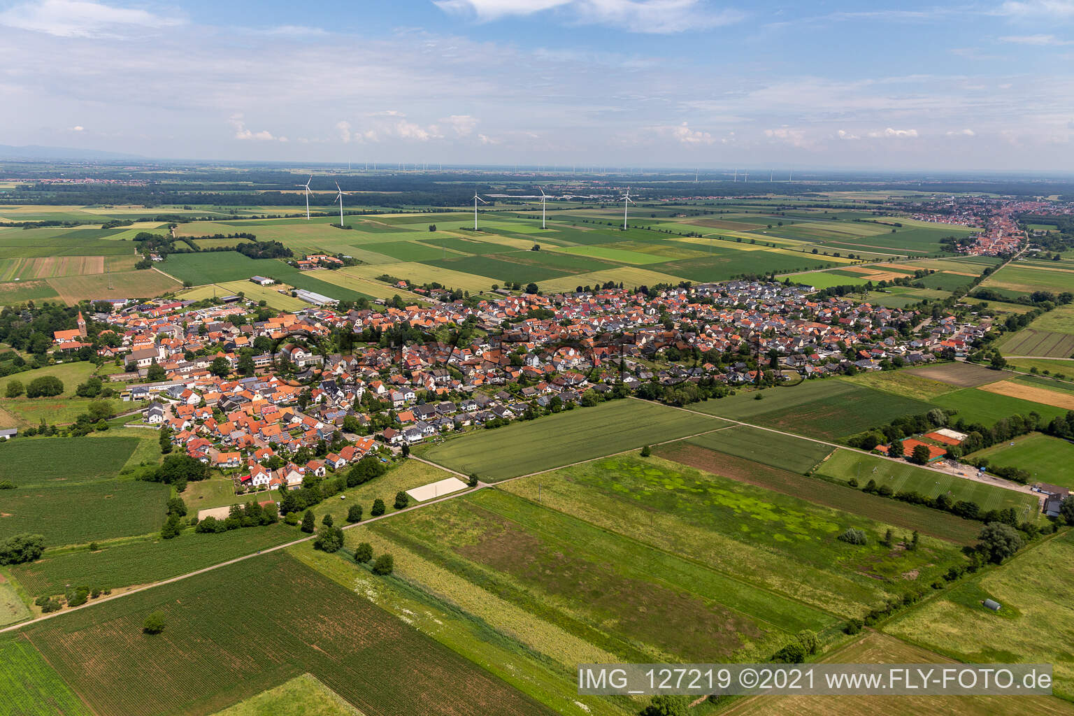 Village view on the edge of agricultural fields and land in Minfeld in the state Rhineland-Palatinate, Germany