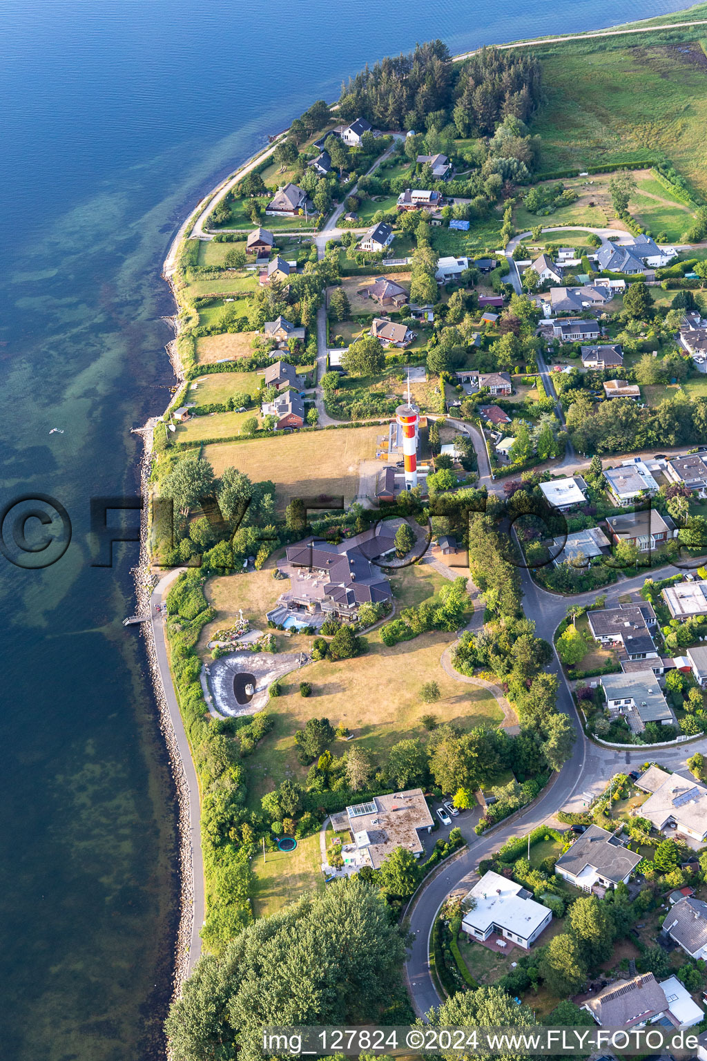 Lighthouse as a historic seafaring character in the coastal area of Foerde in Schausende in the state Schleswig-Holstein, Germany