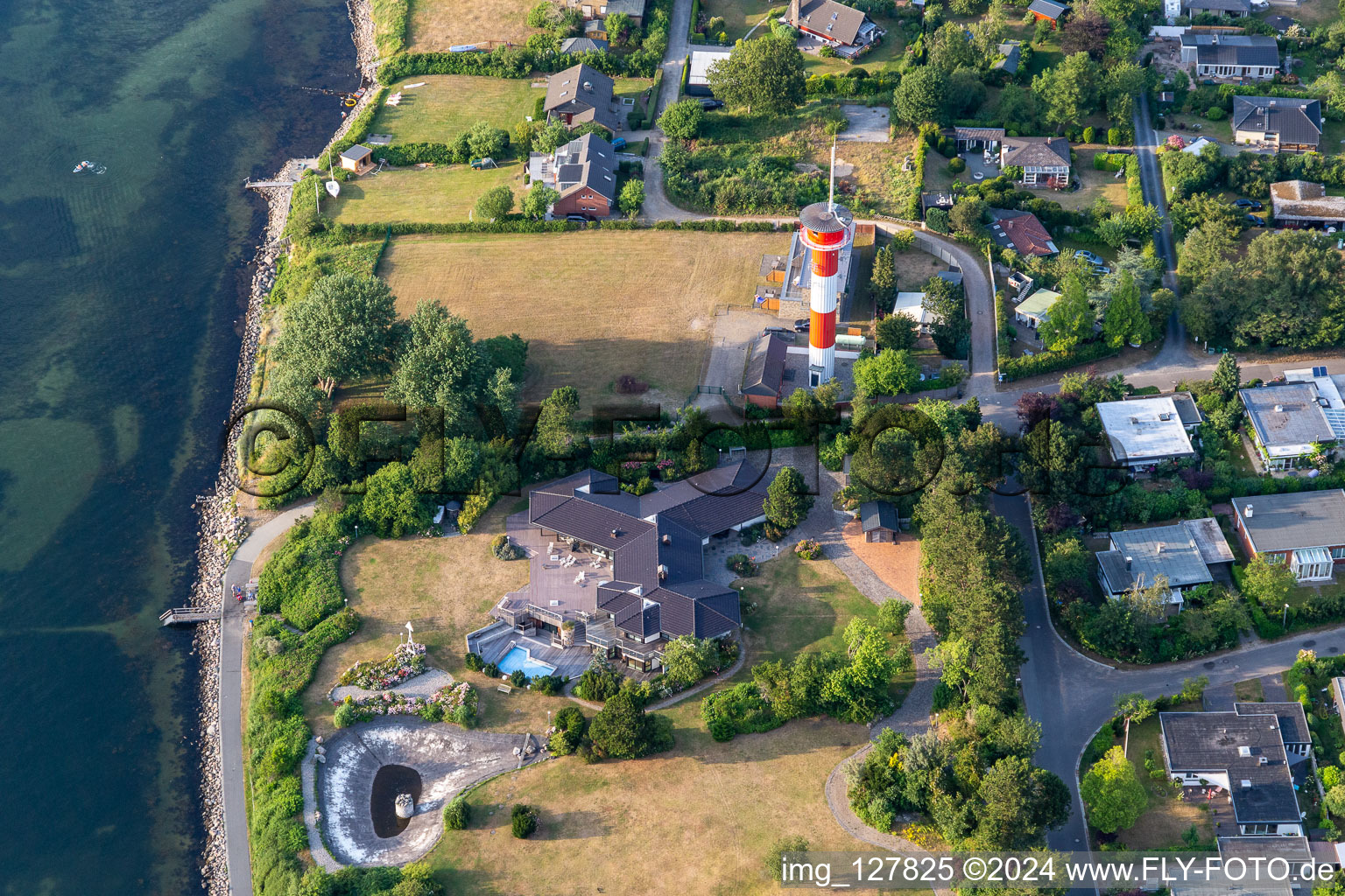 Aerial view of Lighthouse as a historic seafaring character in the coastal area of Foerde in Schausende in the state Schleswig-Holstein, Germany