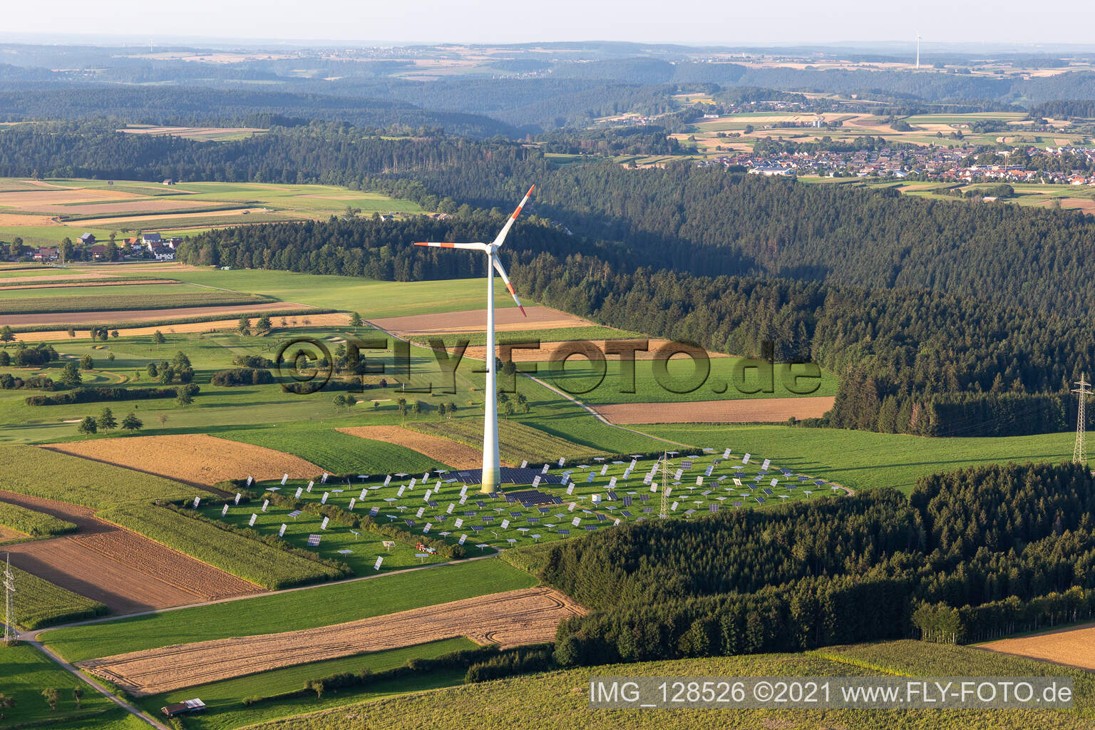 Aerial view of Wind turbine windmills on a solar panel field in Alpirsbach in the state Baden-Wurttemberg, Germany