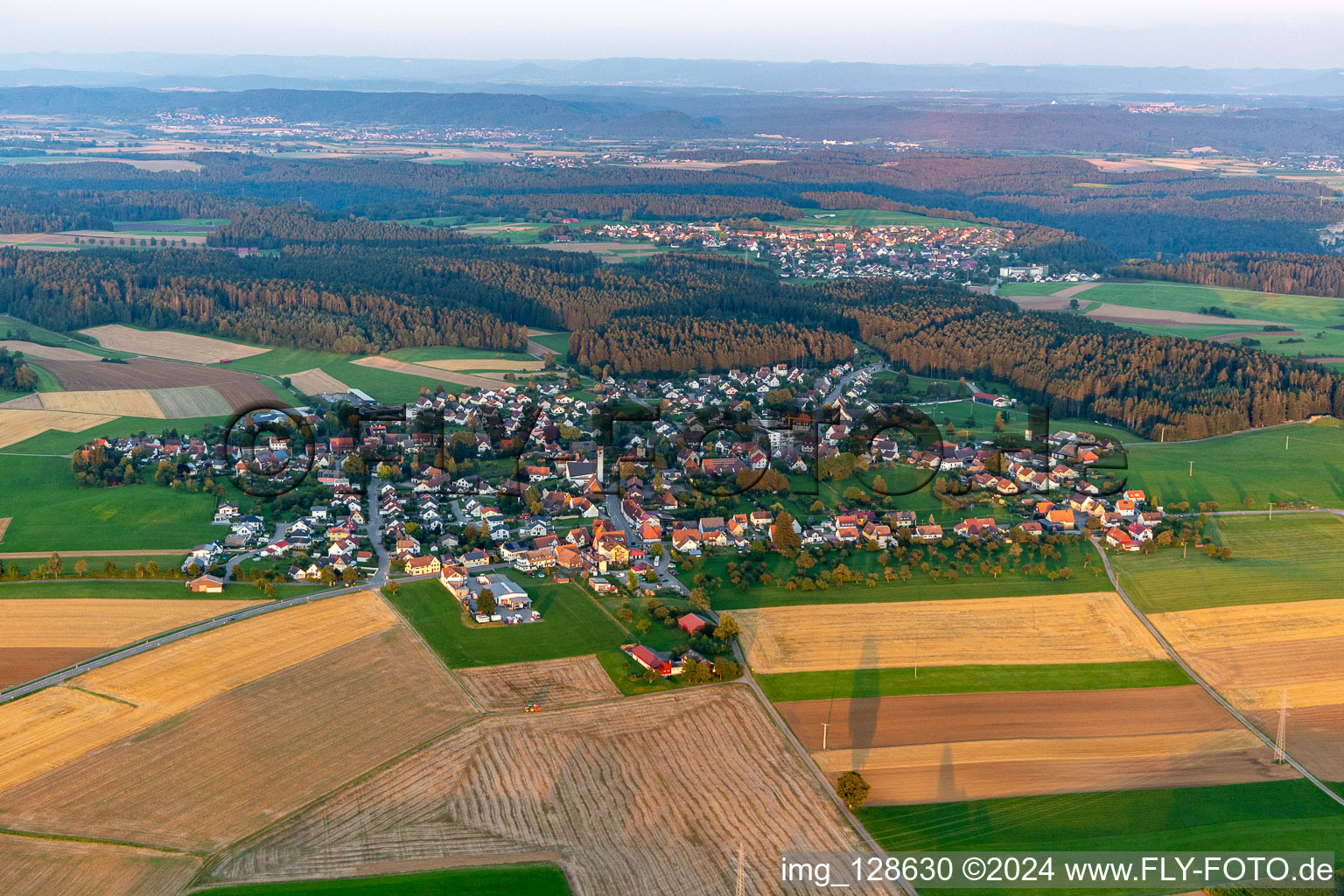 Aerial view of Agricultural land and field boundaries surround the settlement area of the village in Marschalkenzimmern in the state Baden-Wuerttemberg, Germany