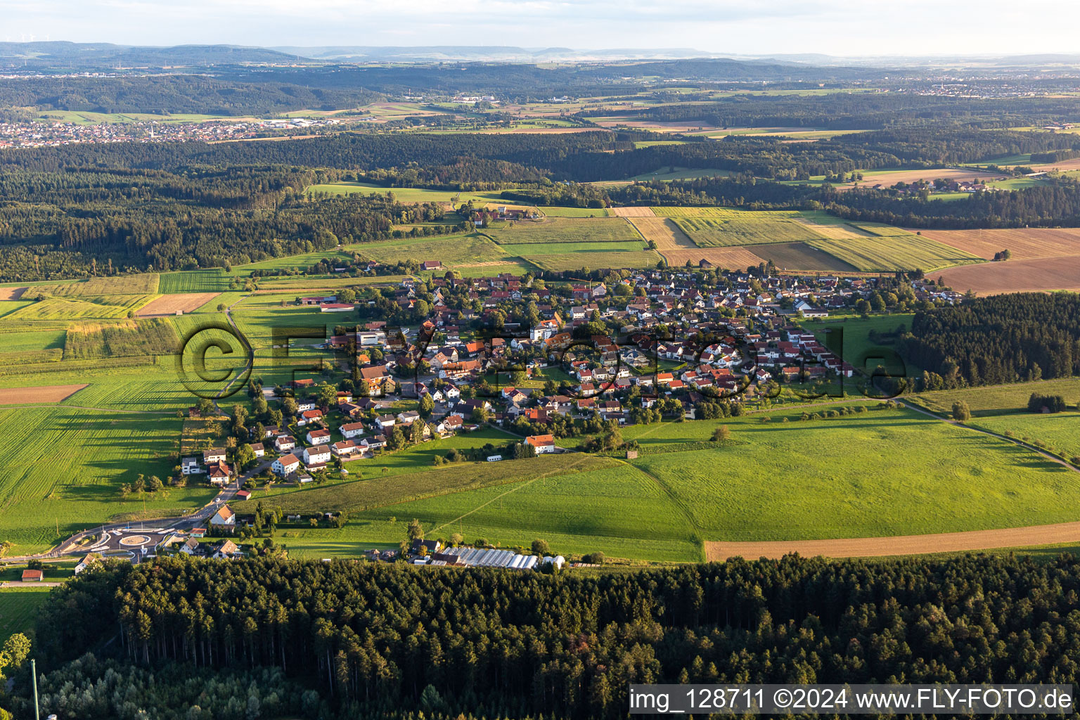 Agricultural land and field boundaries surround the settlement area of the village in Hausen ob Rottweil in the state Baden-Wuerttemberg, Germany