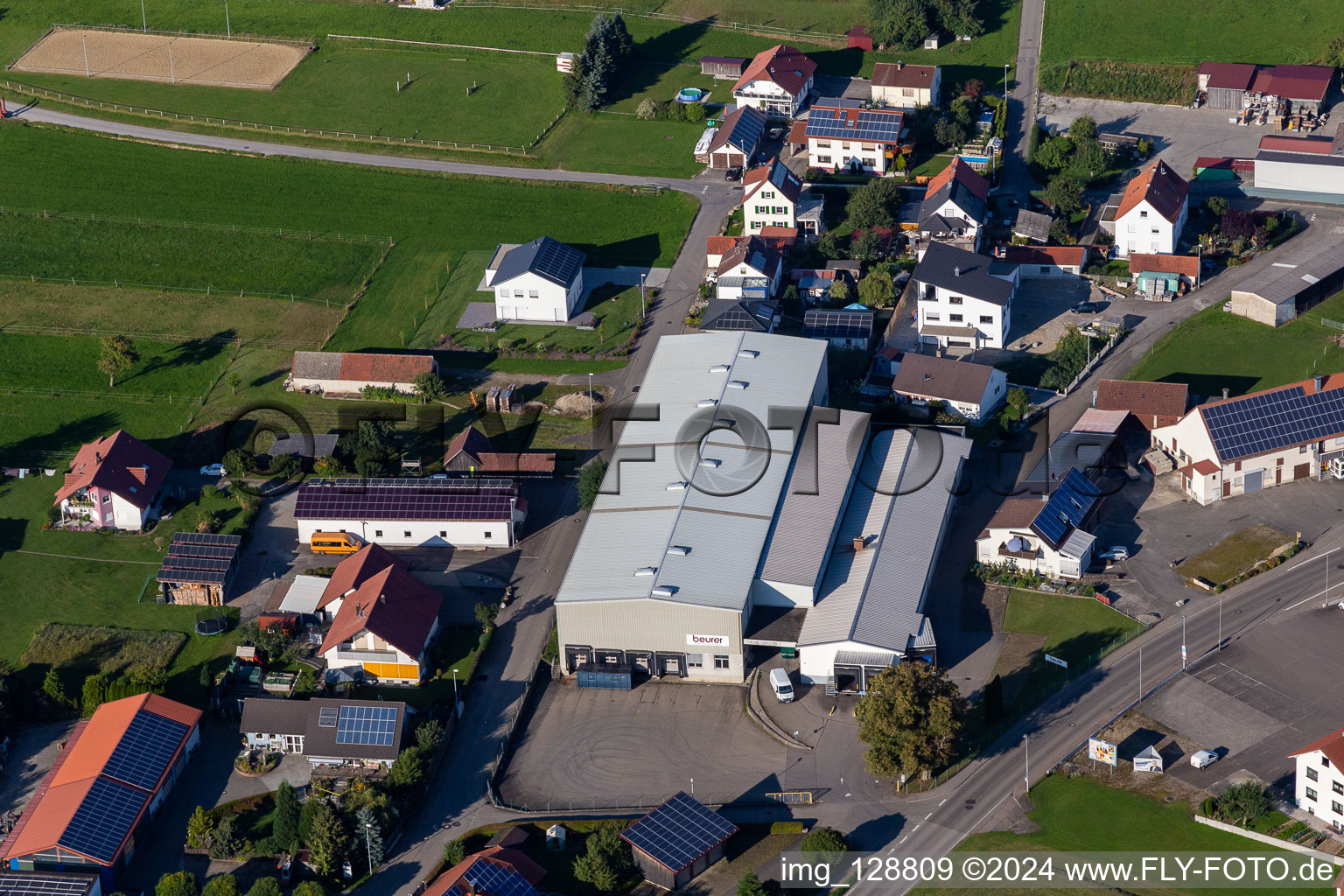 Oblique view of Building and production halls on the premises of Beurer GmbH in Uttenweiler in the state Baden-Wuerttemberg, Germany