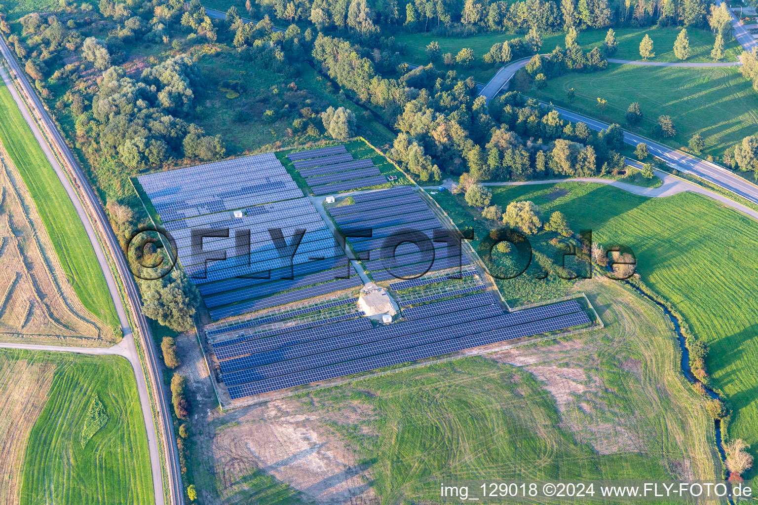 Rows of panels of a solar power plant and photovoltaic system on a field in Ertingen in the state Baden-Wuerttemberg, Germany