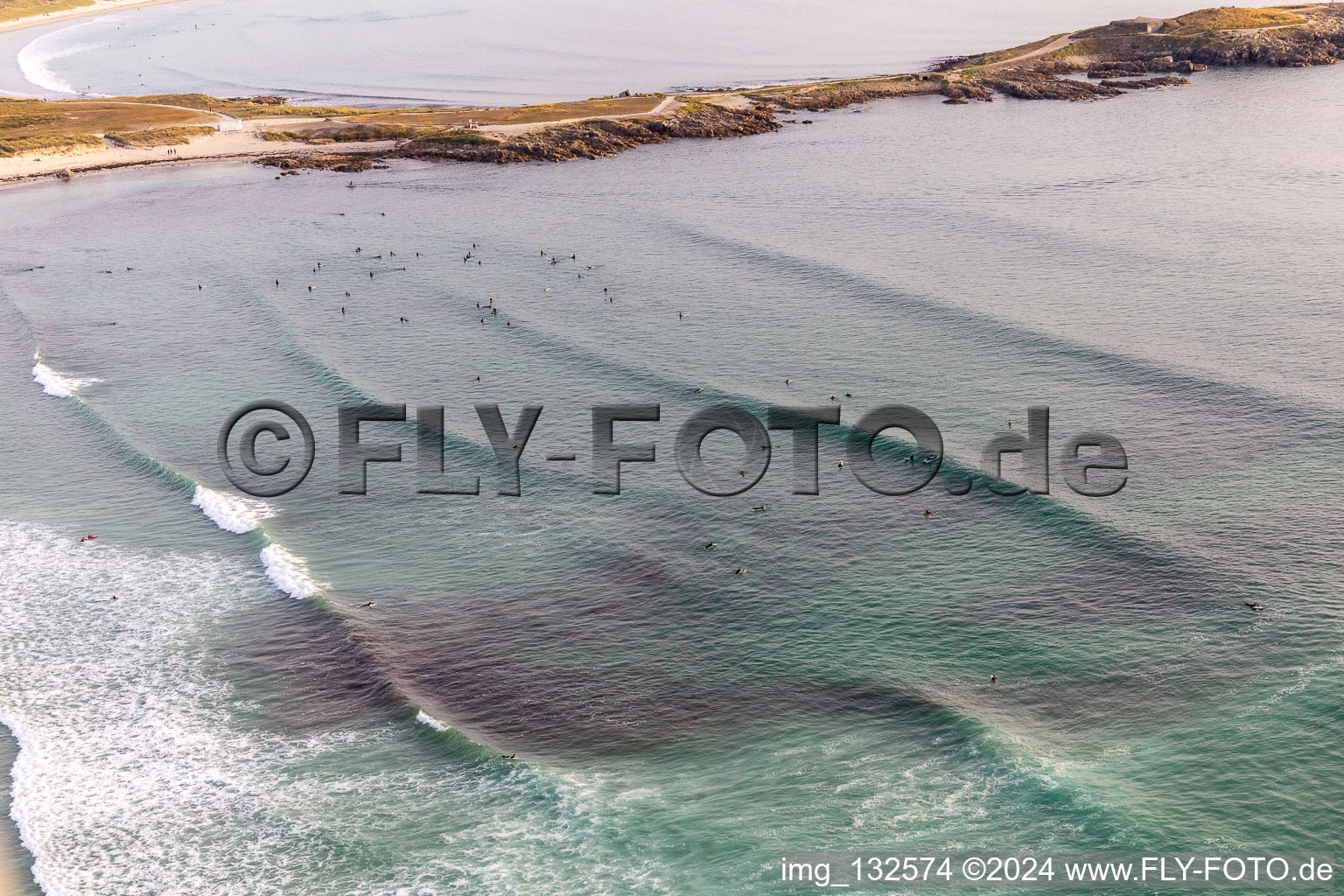 Wave surfers in front of Plage la Torche-Tronoën in Saint-Jean-Trolimon in the state Finistere, France