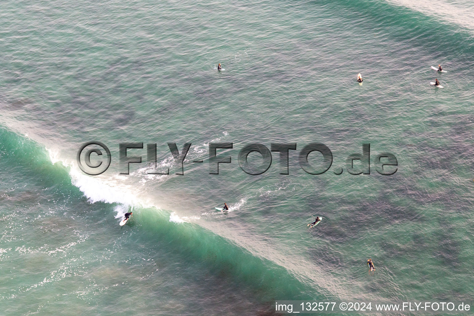 Aerial photograpy of Wave surfers in front of Plage la Torche-Tronoën in Saint-Jean-Trolimon in the state Finistere, France