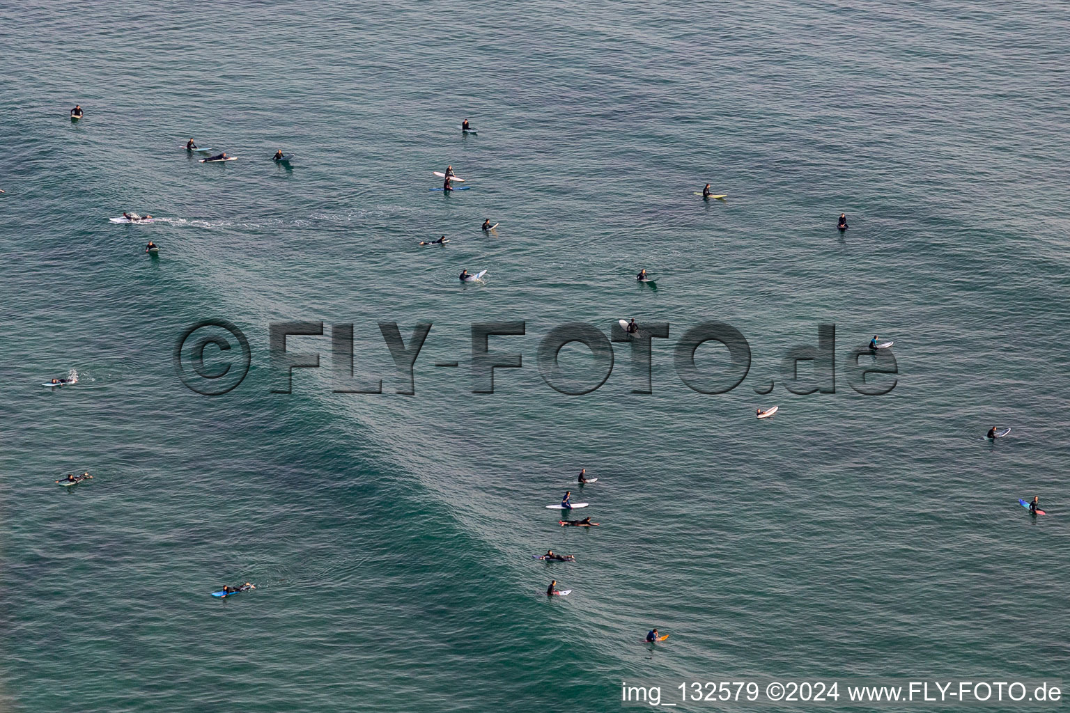 Wave surfers in front of Plage la Torche-Tronoën in Plomeur in the state Finistere, France