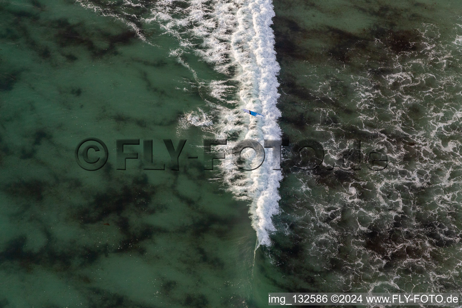 Aerial photograpy of Wave surfers in front of Plage la Torche-Tronoën in Plomeur in the state Finistere, France