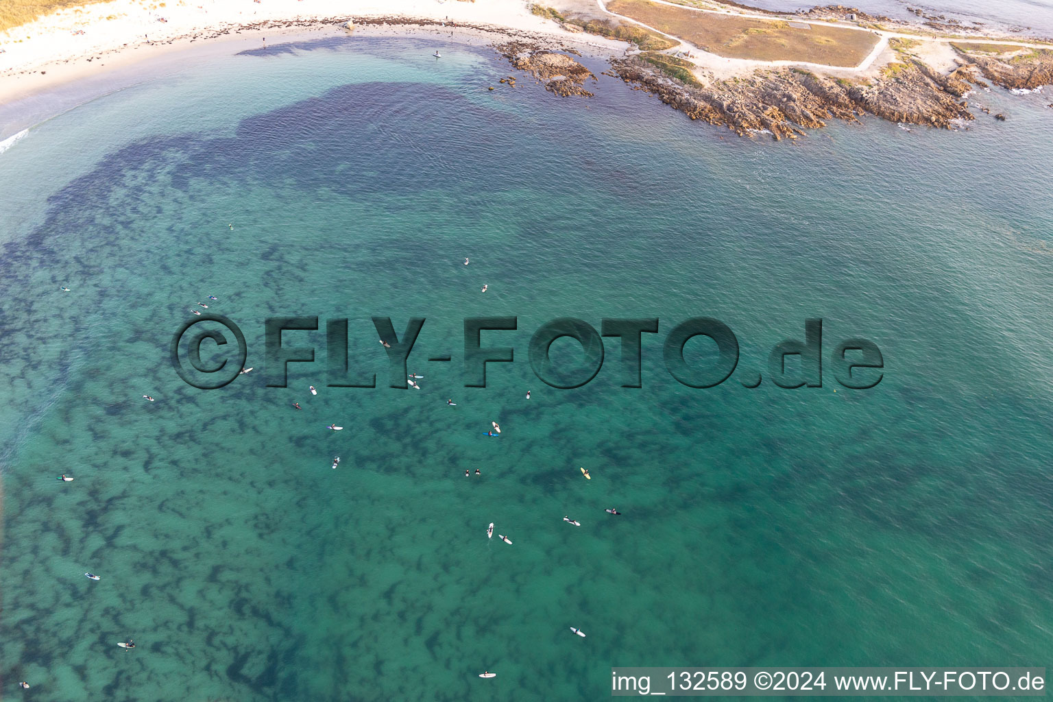 Aerial view of Surfers waiting for the wave in front of the Plage la Torche-Tronoën in Plomeur in the state Finistere, France