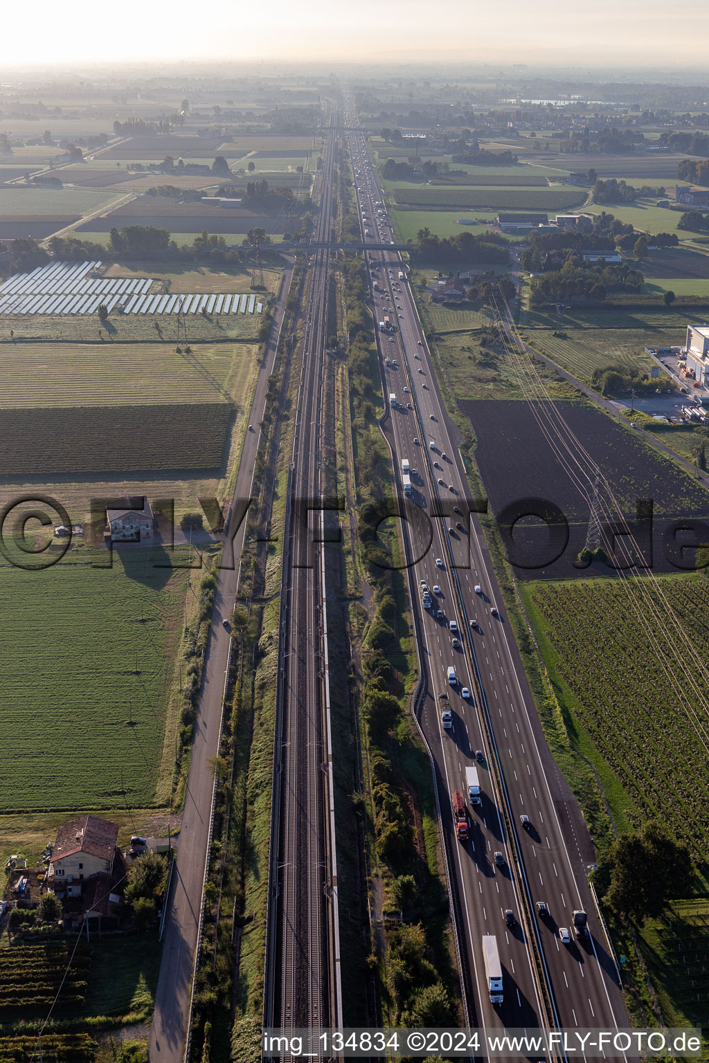 Aerial photograpy of Autostrada del Sole next to the high-speed rail line in San Martino in Rio in the state Reggio Emilia, Italy