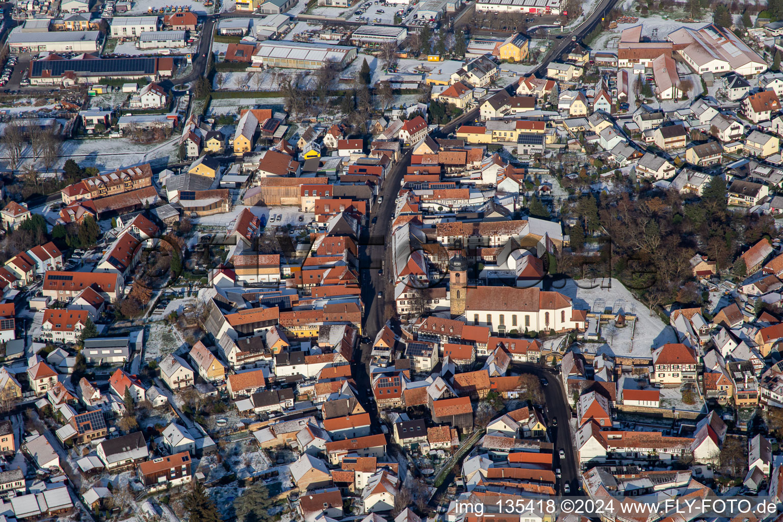 Aerial photograpy of Main street with parish church of St. Michael in winter with snow in Rheinzabern in the state Rhineland-Palatinate, Germany