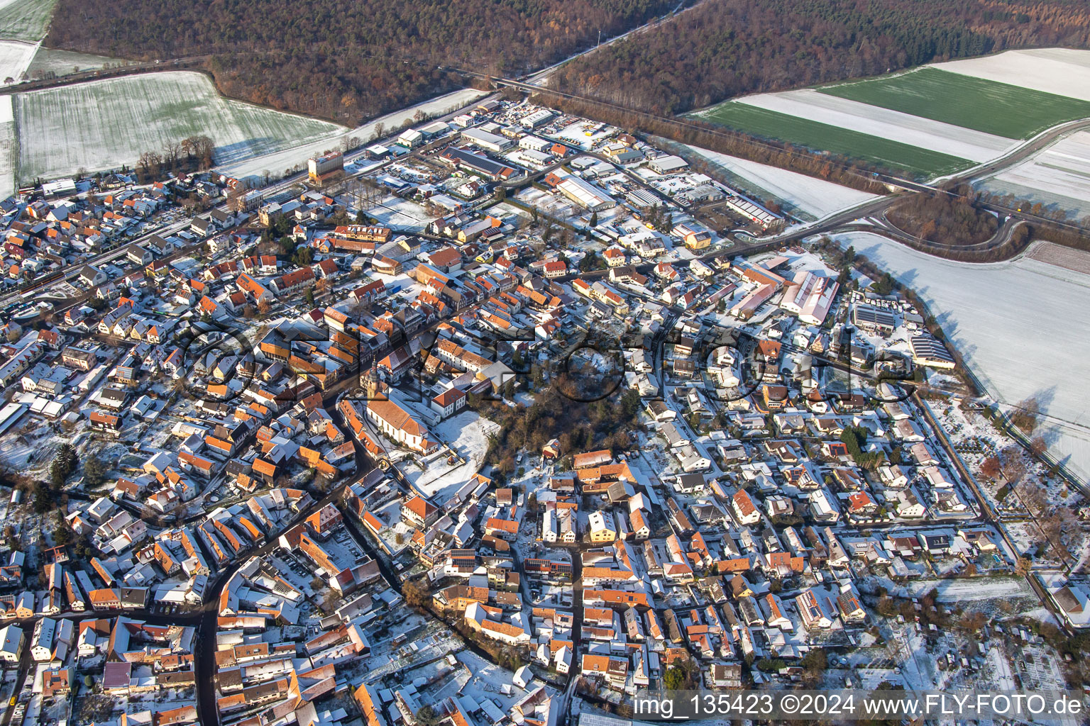 Main street with parish church of St. Michael in winter with snow in Rheinzabern in the state Rhineland-Palatinate, Germany seen from above