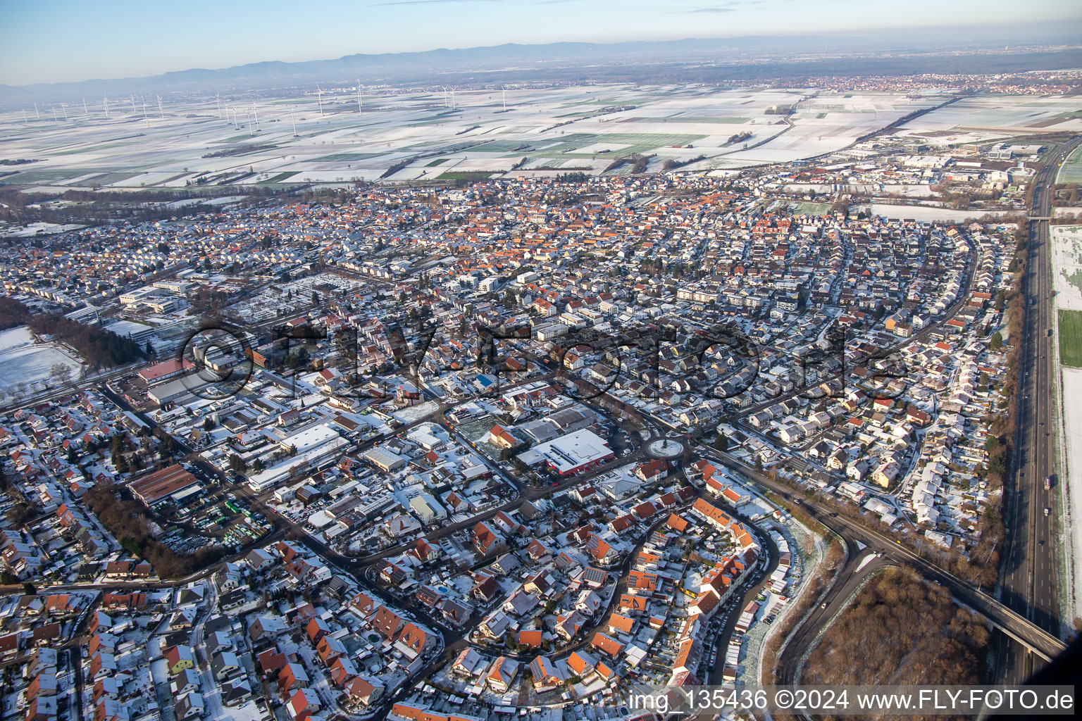 Aerial view of Kuhhardter Straße in winter with snow in Rülzheim in the state Rhineland-Palatinate, Germany