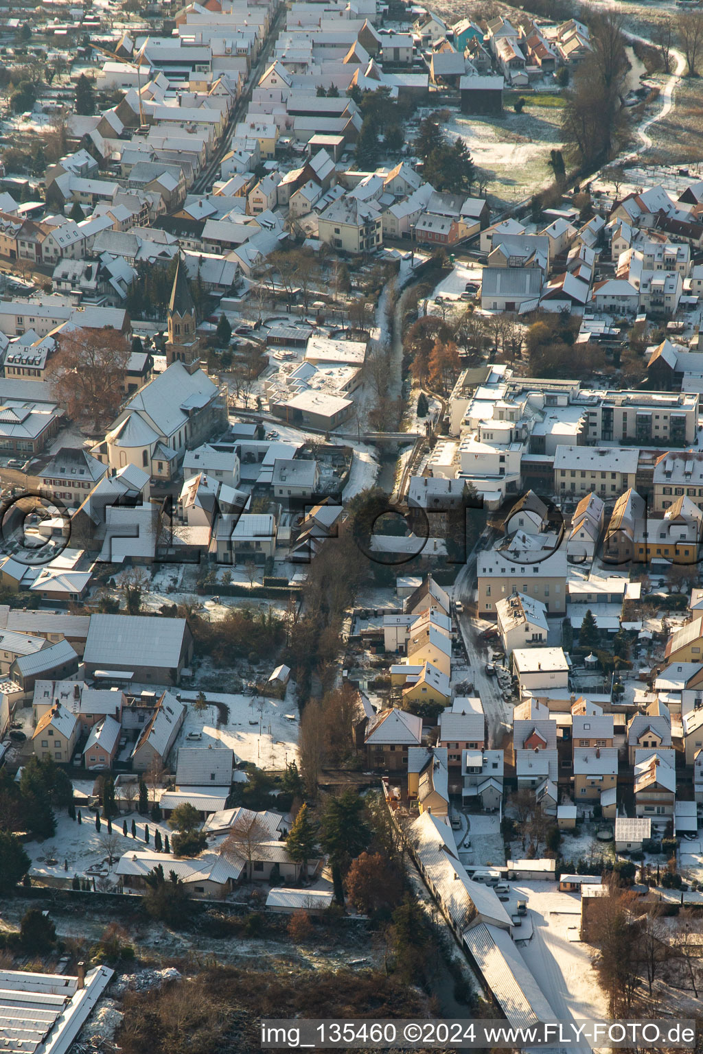 Aerial view of Braun'sche Stiftung and St. Mauritius Church in winter with snow in Rülzheim in the state Rhineland-Palatinate, Germany