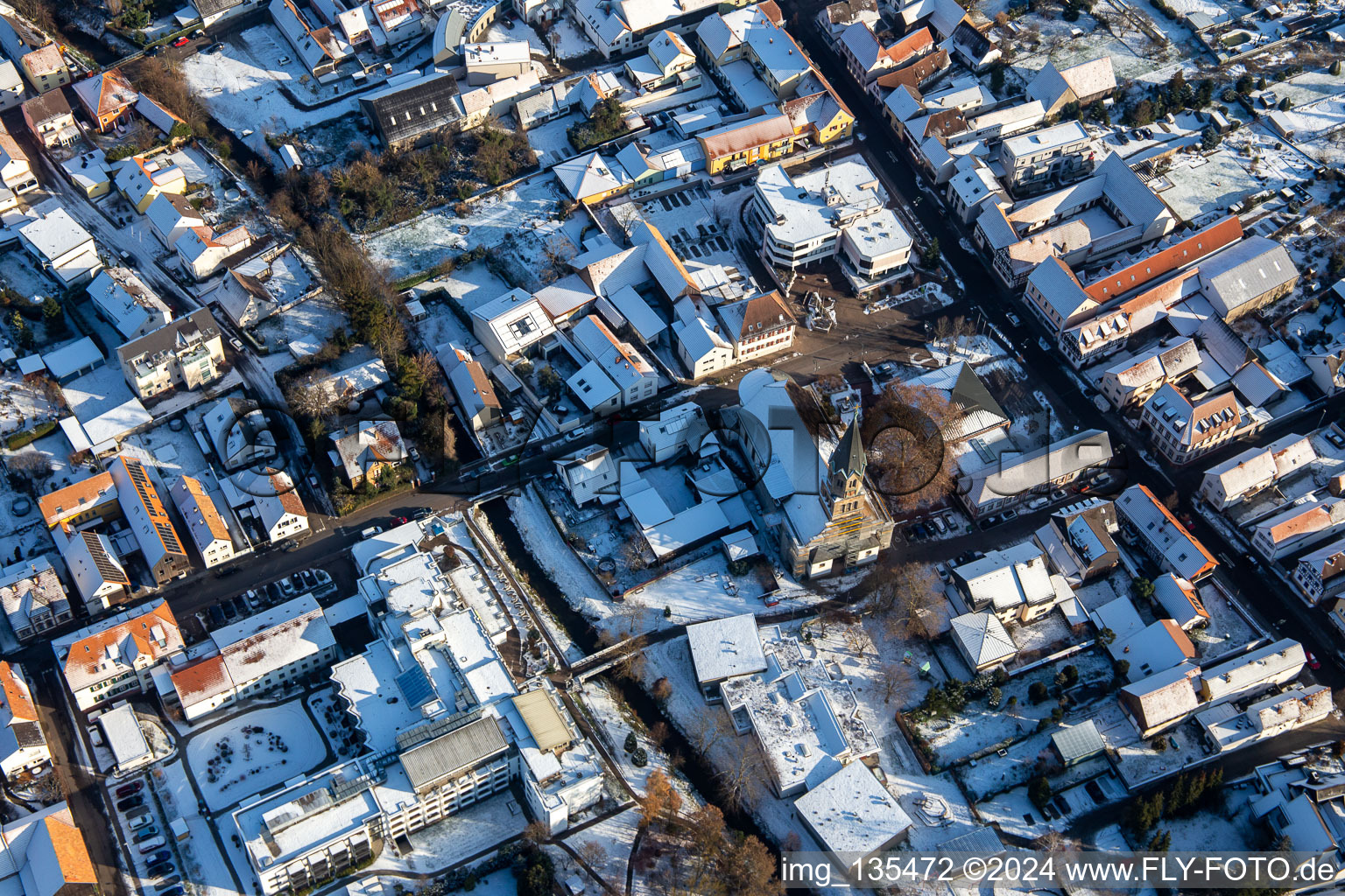 Aerial view of St. Mauritius Church in winter with snow in Rülzheim in the state Rhineland-Palatinate, Germany