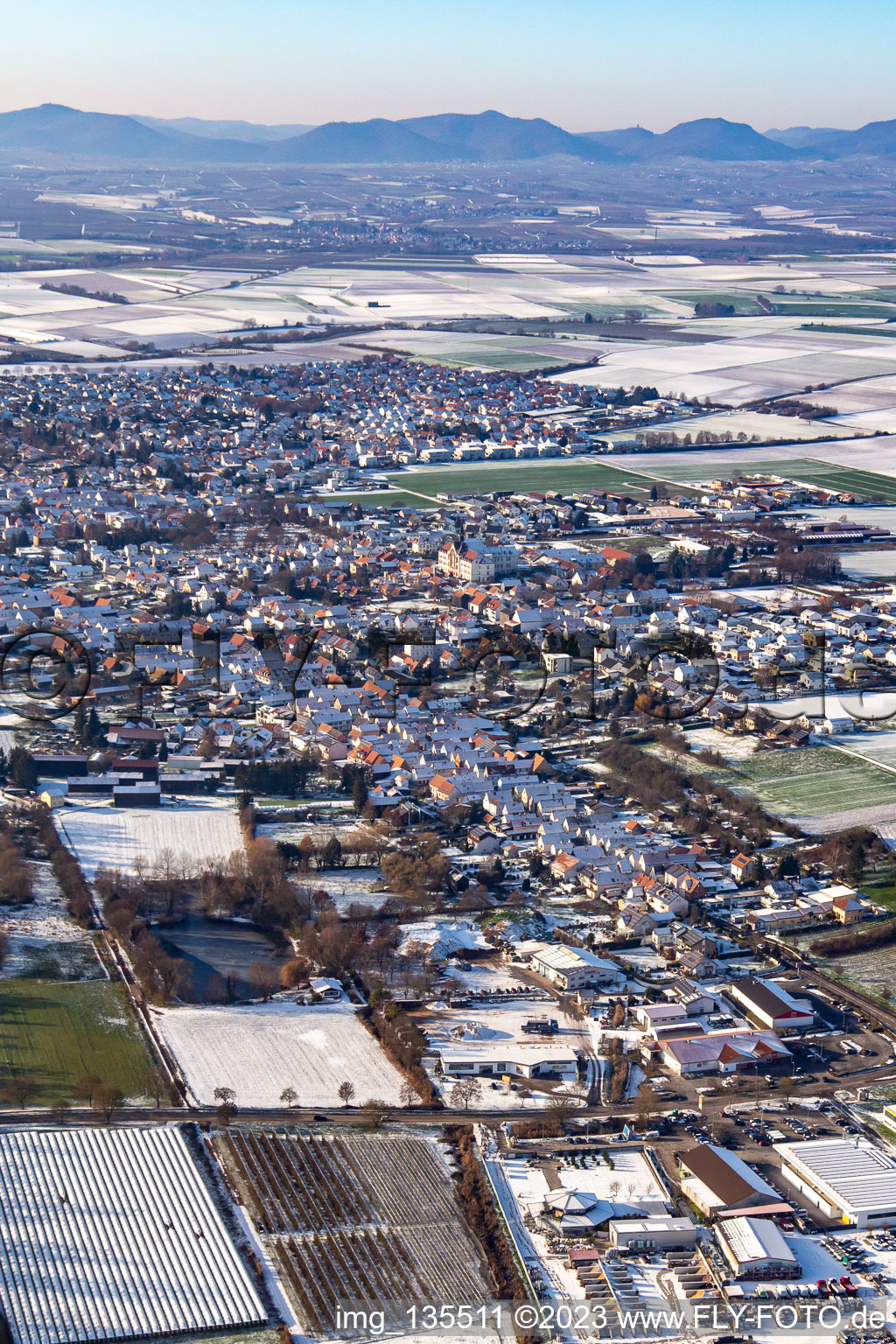 Aerial view of Lower main street in winter with snow in the district Herxheim in Herxheim bei Landau in the state Rhineland-Palatinate, Germany