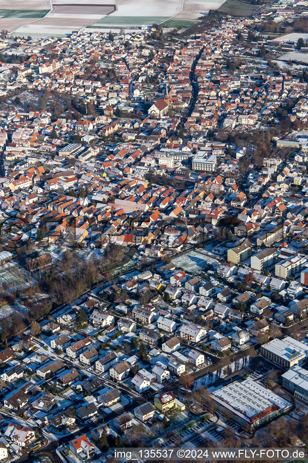 Aerial view of Upper main street in winter with snow in the district Herxheim in Herxheim bei Landau in the state Rhineland-Palatinate, Germany