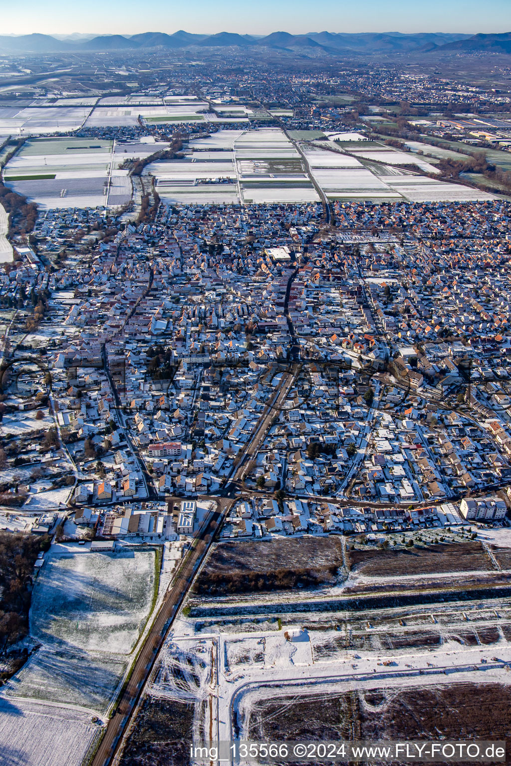 Germersheimer Straße from the east in winter with snow in Offenbach an der Queich in the state Rhineland-Palatinate, Germany