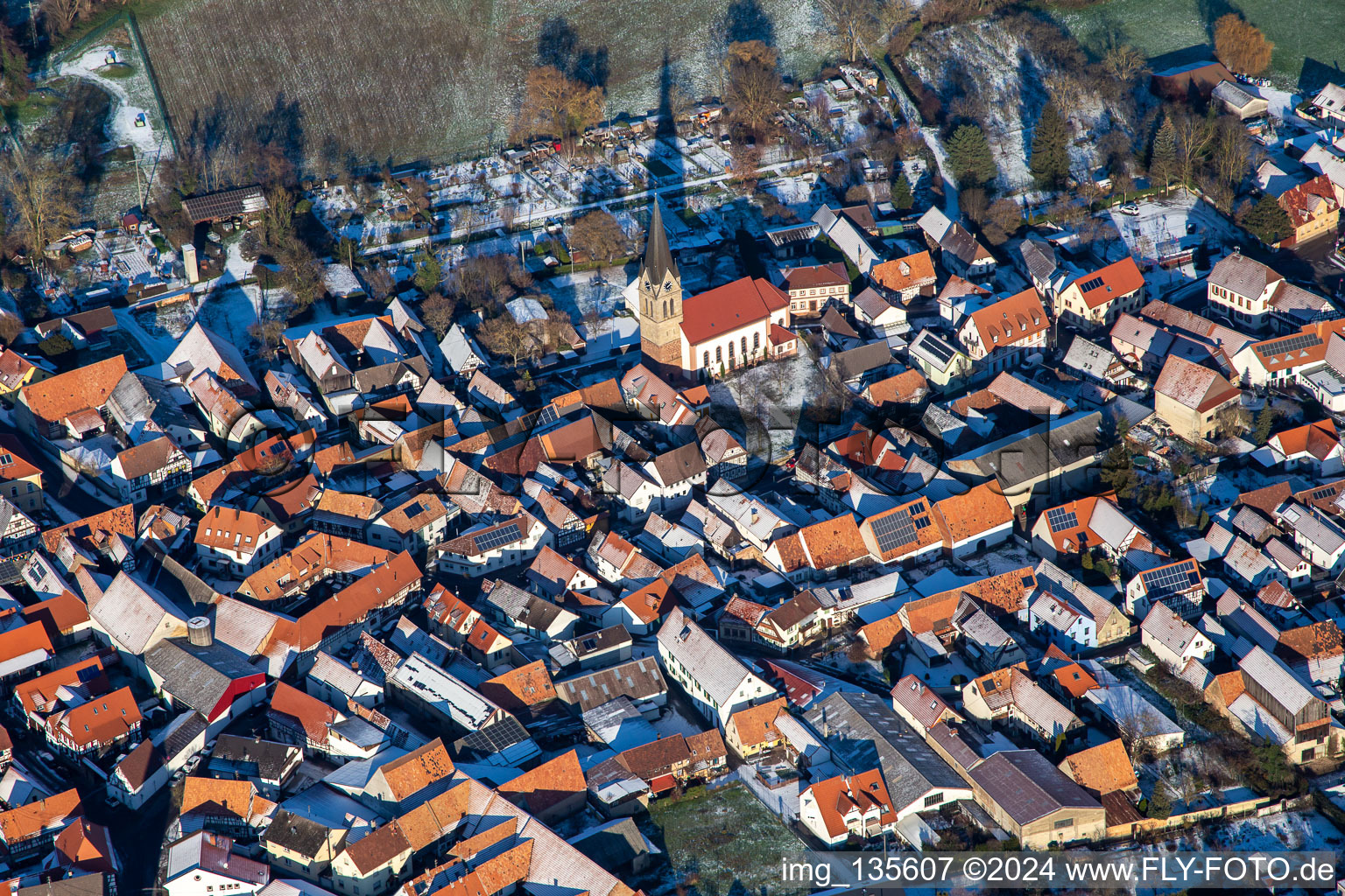 Aerial view of Church of St. Martin in winter with snow in Steinweiler in the state Rhineland-Palatinate, Germany