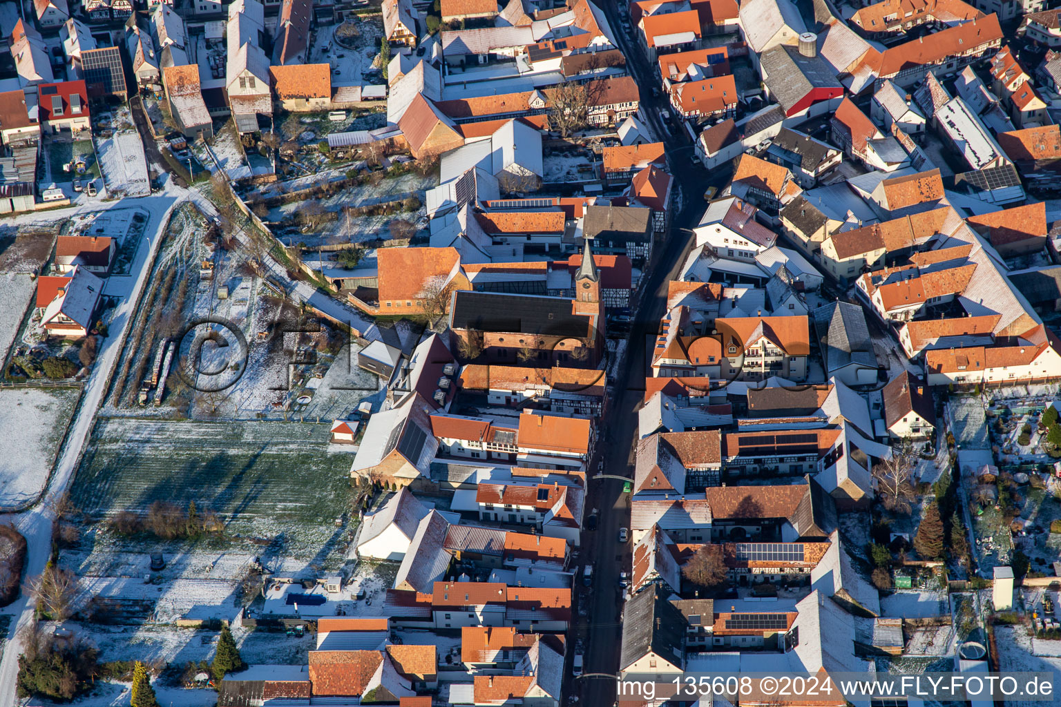 Aerial view of Protestant church in winter with snow in Steinweiler in the state Rhineland-Palatinate, Germany