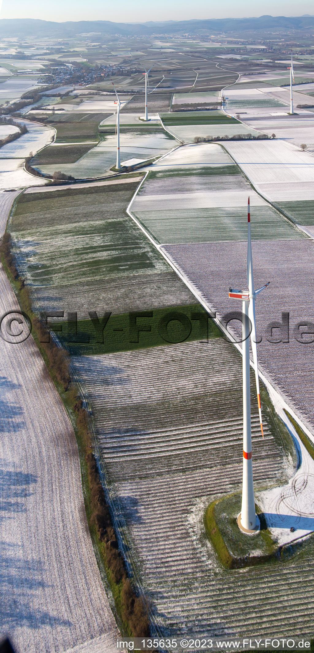 Aerial view of Wind farm in winter with snow in Freckenfeld in the state Rhineland-Palatinate, Germany