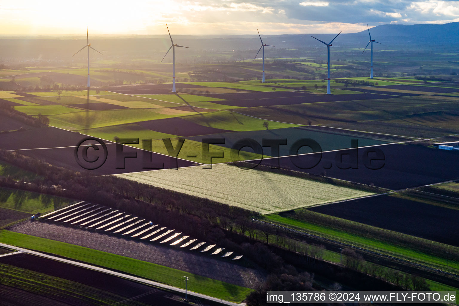 Aerial view of PV solar field in front of the Freckenfeld wind farm in Winden in the state Rhineland-Palatinate, Germany