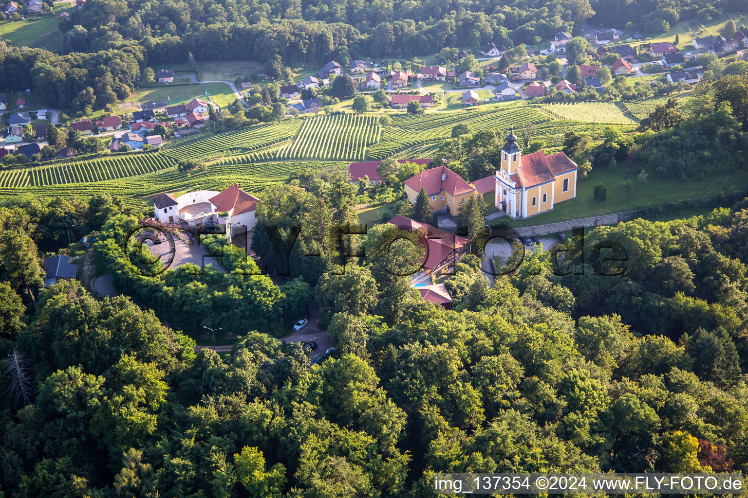 Aerial photograpy of Church of Župnijska cerkev sv. Marije Vnebovzete and Café Huda Liza on the Vurberg in Duplek in the state Slovenia, Slovenia