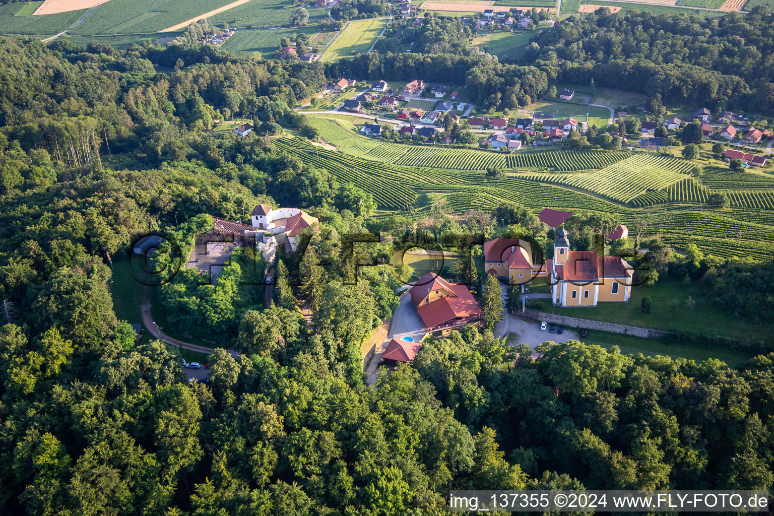 Oblique view of Church of Župnijska cerkev sv. Marije Vnebovzete and Café Huda Liza on the Vurberg in Duplek in the state Slovenia, Slovenia