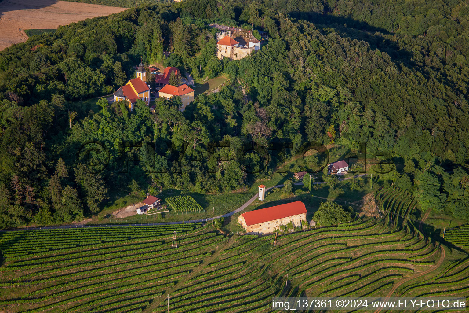 Church of Župnijska cerkev sv. Marije Vnebovzete and Café Huda Liza on the Vurberg in Duplek in the state Slovenia, Slovenia from above