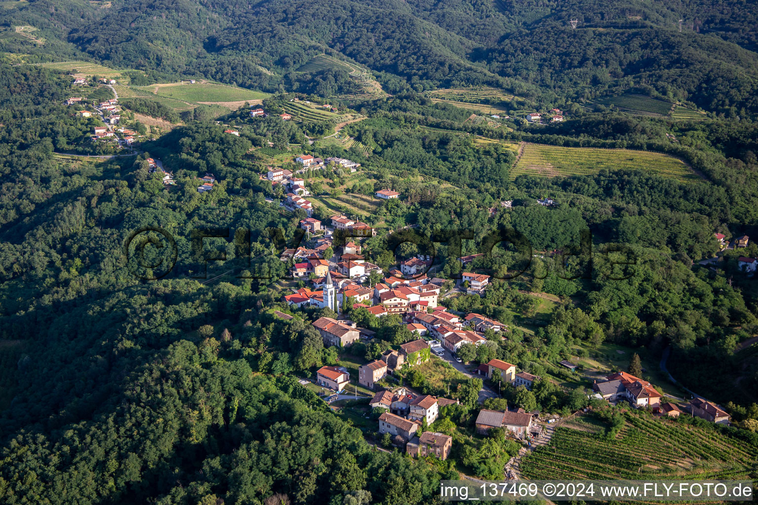 Aerial photograpy of Hilltop village between vines and forest in the district Gradišče nad Prvačino in Nova Gorica in the state Slovenia, Slovenia