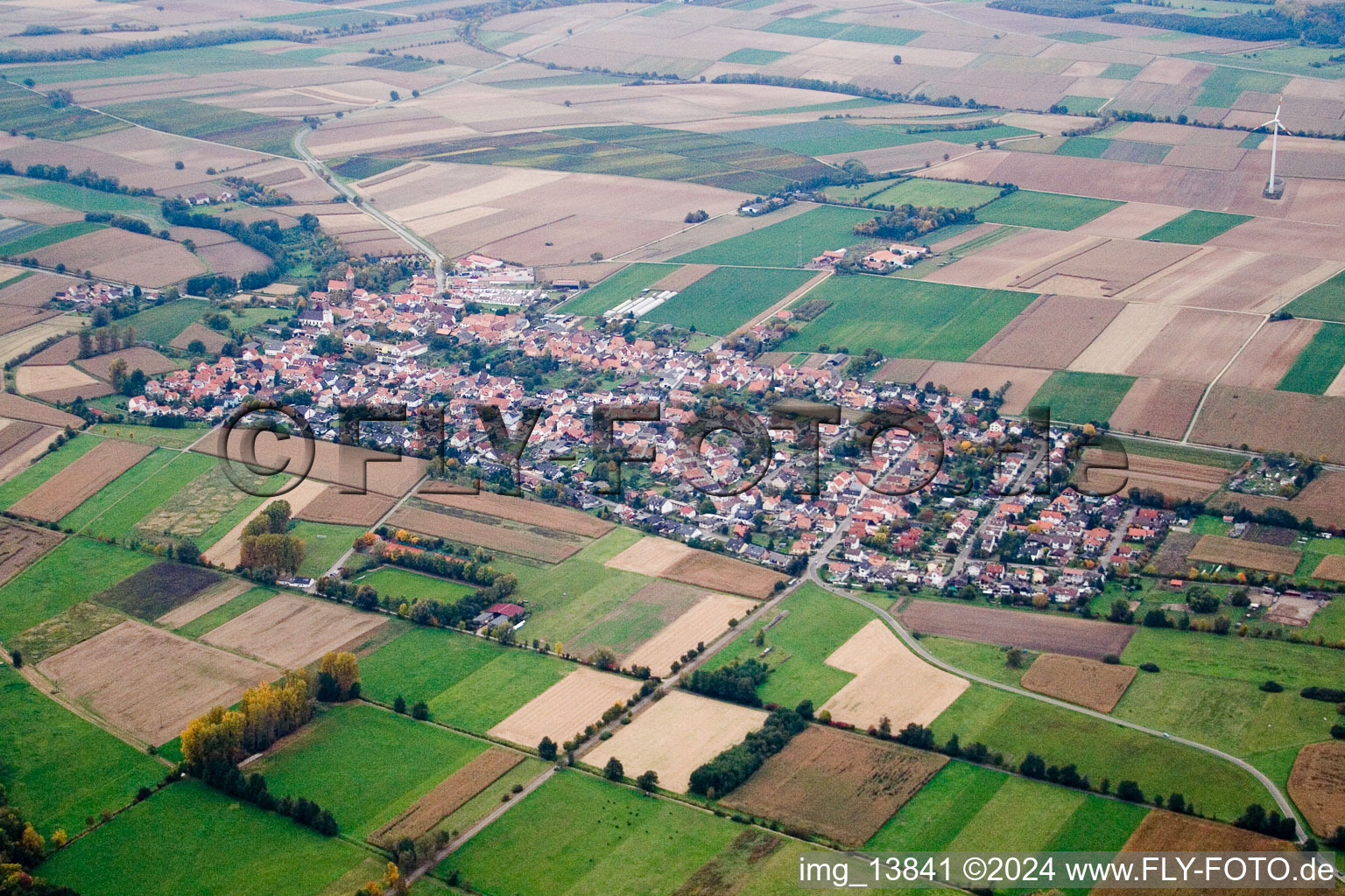 Village - view on the edge of agricultural fields and farmland in Minfeld in the state Rhineland-Palatinate