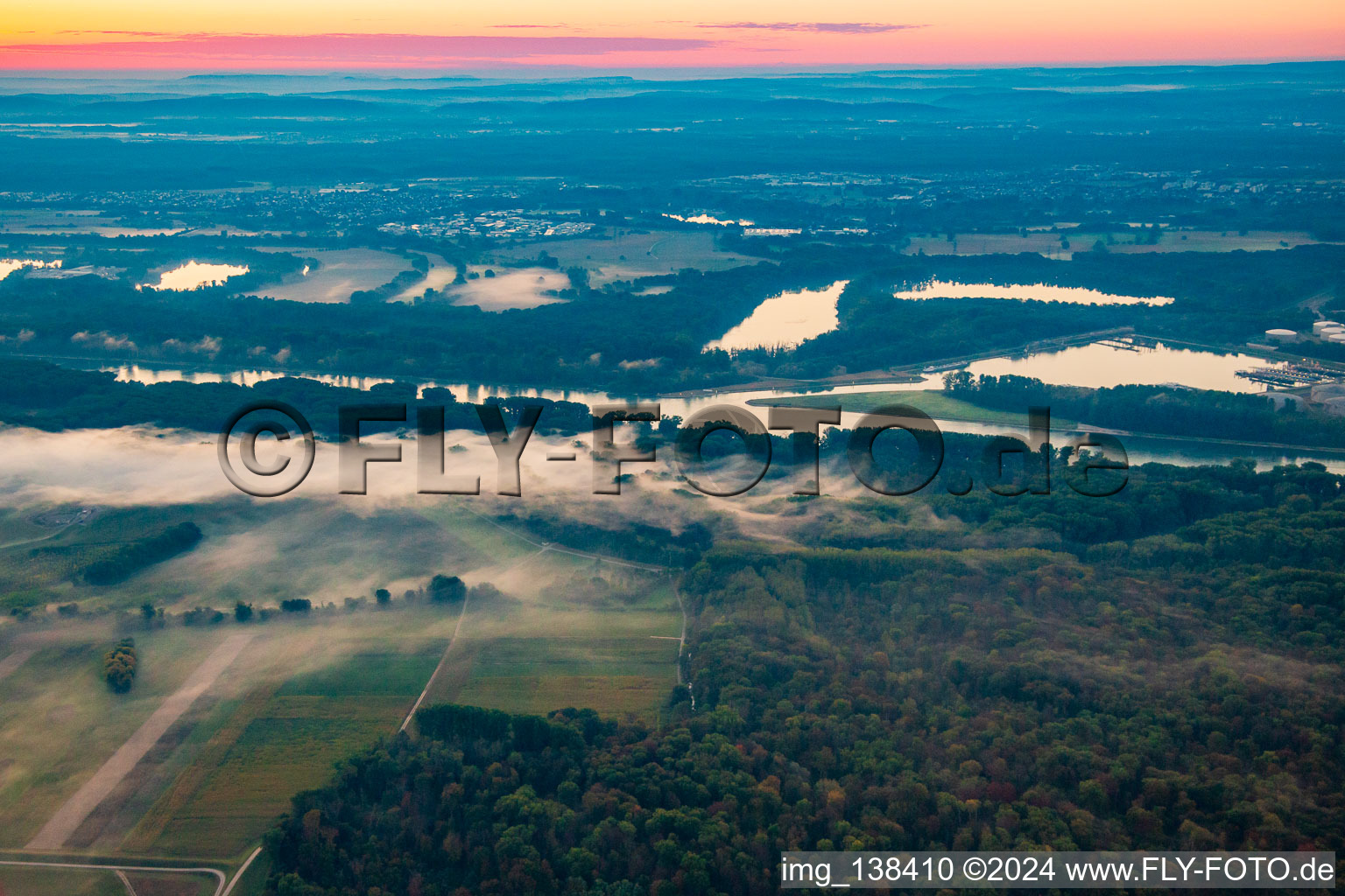 Rhine meadows in the morning mist before sunrise in the district Knielingen in Karlsruhe in the state Baden-Wuerttemberg, Germany