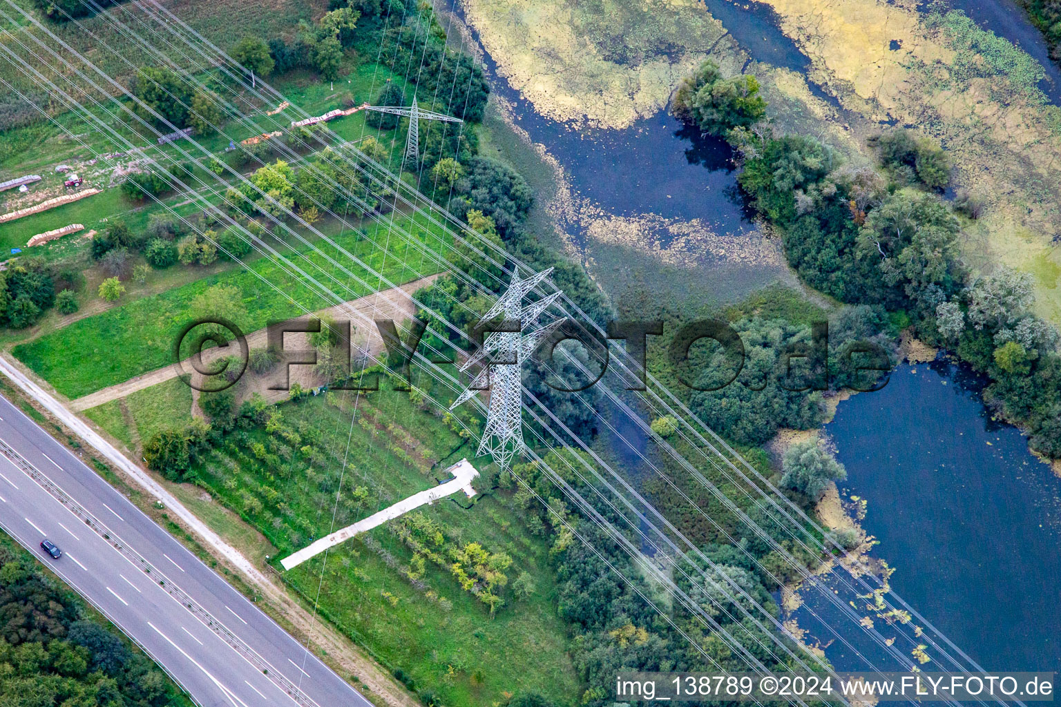 Crossing high-voltage lines in Wörth am Rhein in the state Rhineland-Palatinate, Germany